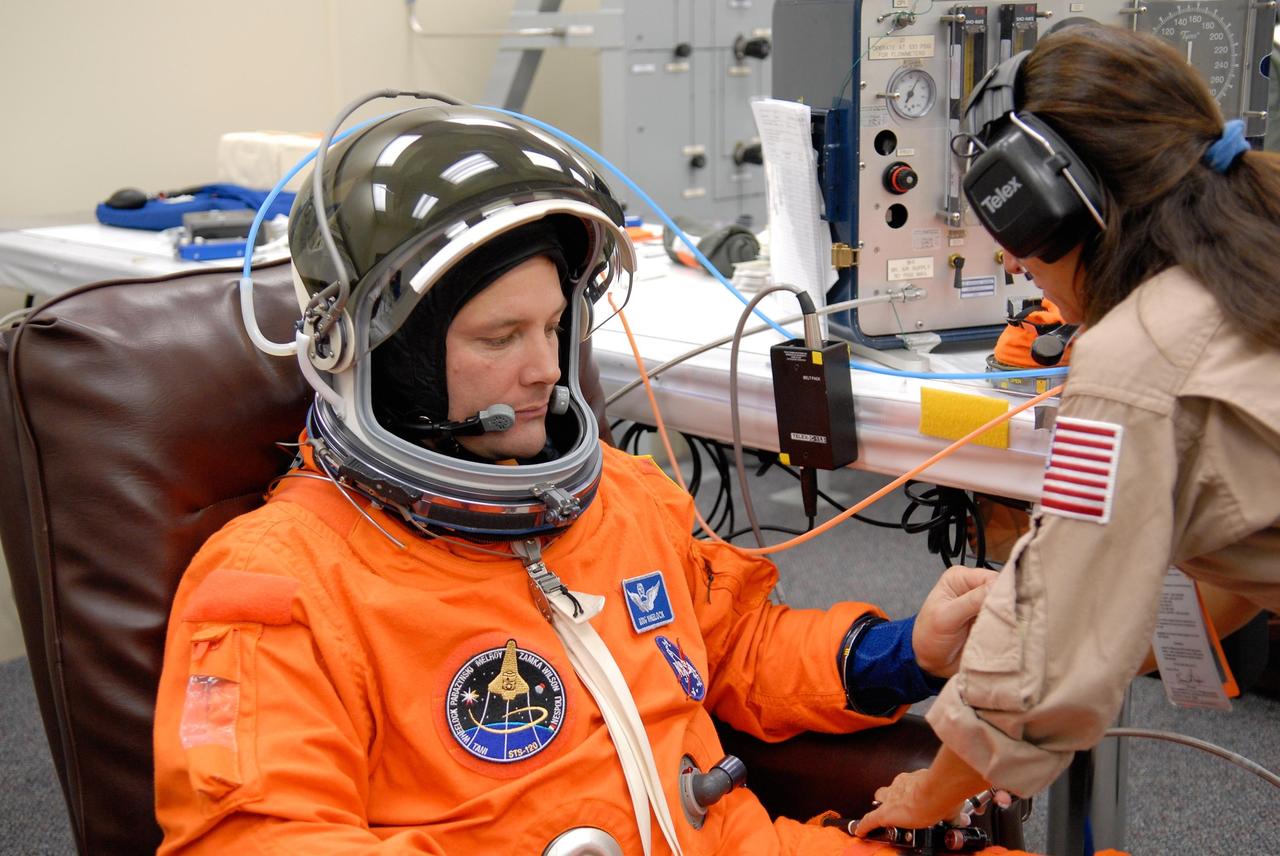 KENNEDY SPACE CENTER, FLA. -- STS-120 Mission Specialist Doug Wheelock tries on his launch and entry suit to prepare for launch. The fitting is part of terminal countdown demonstration test, or TCDT, activities the crew is undertaking at NASA's Kennedy Space Center. The TCDT also includes emergency egress procedures, equipment familiarization and a simulated launch countdown. Mission STS-120, which will carry the Italian-built U.S. Node 2 to the International Space Station, is targeted for launch on Oct. 23. Photo credit: NASA/Kim Shiflett