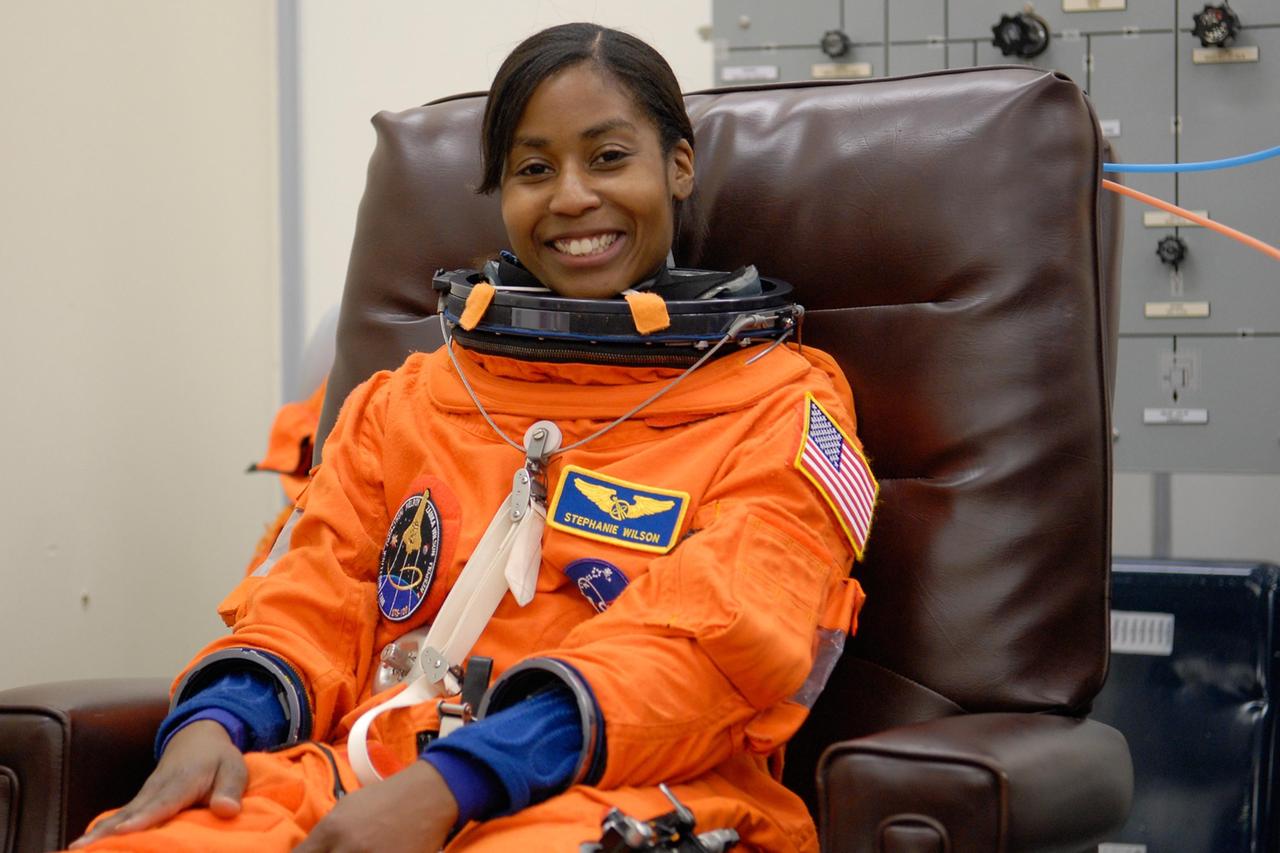 KENNEDY SPACE CENTER, FLA. -- STS-120 Mission Specialist Stephanie Wilson tries on her launch and entry suit, preparing for launch. The fitting is part of terminal countdown demonstration test, or TCDT, activities the crew is undertaking at NASA's Kennedy Space Center. The TCDT also includes emergency egress procedures, equipment familiarization and a simulated launch countdown. Mission STS-120, which will carry the Italian-built U.S. Node 2 to the International Space Station, is targeted for launch on Oct. 23. Photo credit: NASA/Kim Shiflett