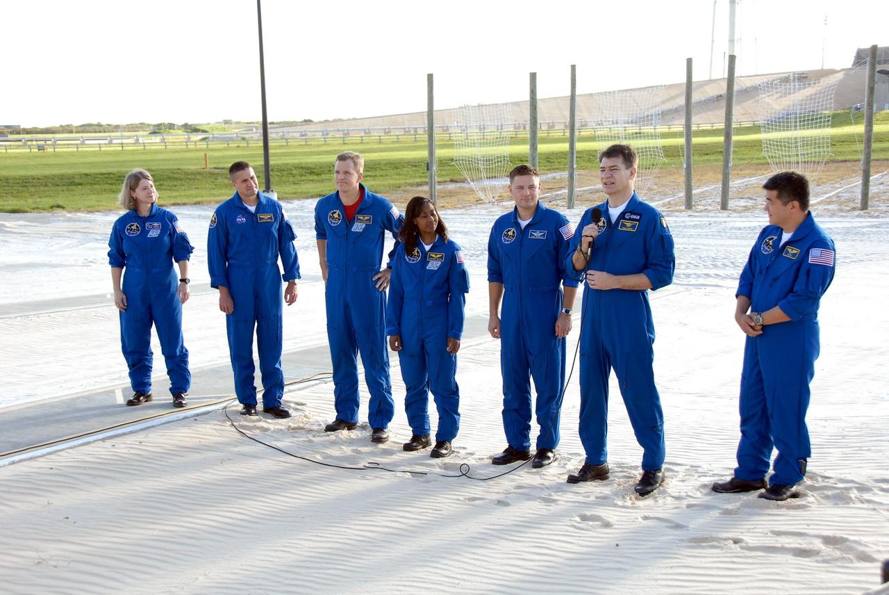 KENNEDY SPACE CENTER, FLA. --  At the slidewire basket landing on Launch Pad 39A, the STS-120 crew responds to questions from the media.  With the microphone is Mission Specialist Paolo Nespoli, who represents the European Space Agency.  The rest of the crew are, from left, Commander Pamela Melroy, Pilot George Zamka and Mission Specialists Scott Parazynski, Stephanie Wilson, Doug Wheelock and Daniel Tani.  Mission STS-120, which will carry the Italian-built U.S. Node 2 to the International Space Station, is targeted for launch on Oct. 23. Tani will remain aboard the station and return with the STS-122 crew, targeted to launch Dec. 6.  Photo credit: NASA/Kim Shiflett
