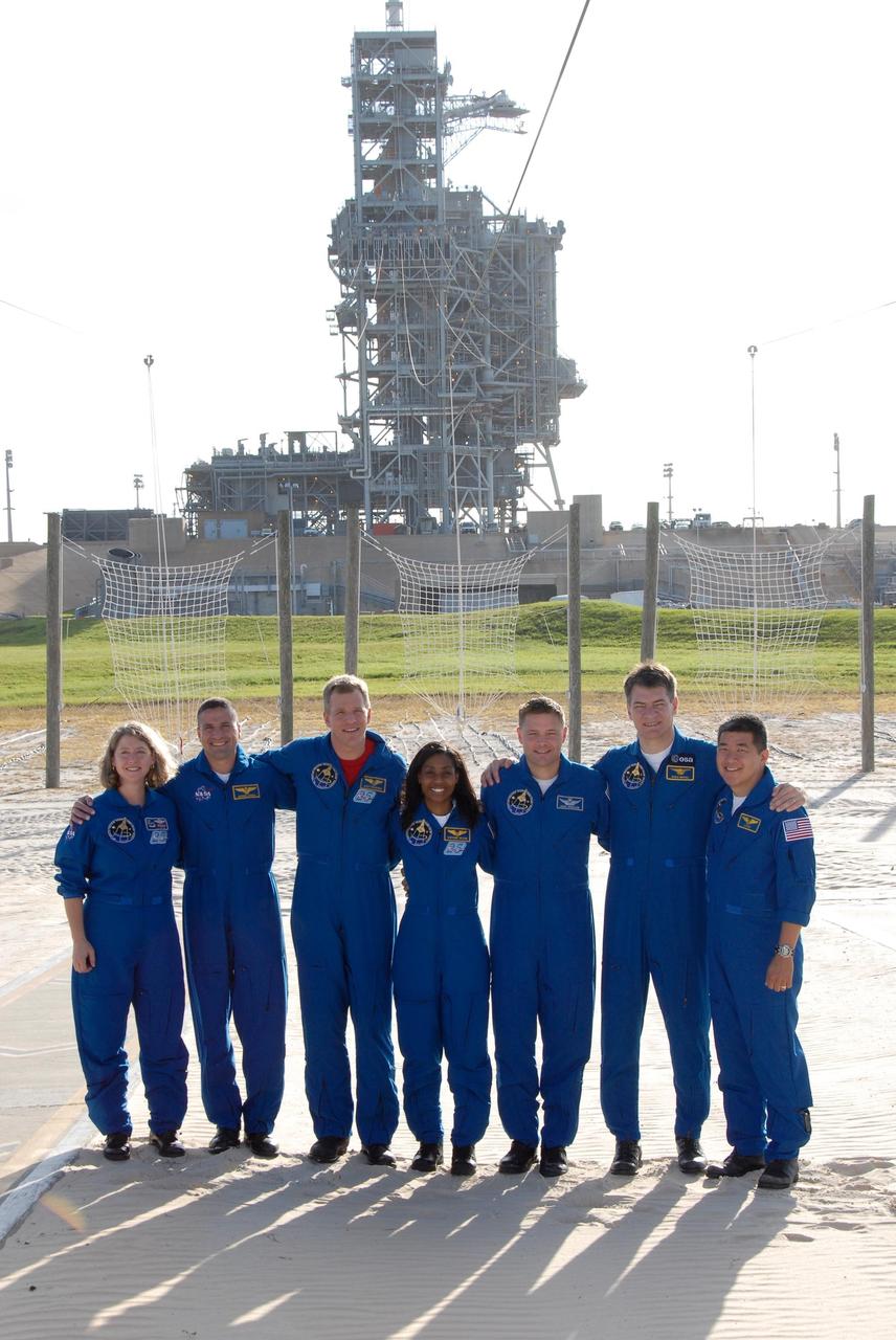 KENNEDY SPACE CENTER, FLA. --  The STS-120 crew takes a moment for a group photo at the slidewire basket landing on Launch Pad 39A after taking part in a press conference.  From left are Commander Pamela Melroy, Pilot George Zamka and Mission Specialists Scott Parazynski, Stephanie Wilson, Doug Wheelock, Paolo Nespoli and Daniel Tani.  Nespoli represents the European Space Agency.  The crew is at NASA's Kennedy Space Center to take part in terminal countdown demonstration test activities that include emergency egress procedures and a simulated launch countdown.  Mission STS-120, which will carry the Italian-built U.S. Node 2 to the International Space Station, is targeted for launch on Oct. 23. Tani will remain aboard the station and return with the STS-122 crew, targeted to launch Dec. 6.  Photo credit: NASA/Kim Shiflett
