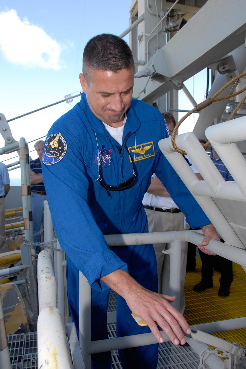 KENNEDY SPACE CENTER, FLA. -- The STS-120 crew is at NASA's Kennedy Space Center for the pre-launch terminal countdown demonstration test, or TCDT. Here, during emergency egress training, Pilot George Zamka touches the handle that releases the slidewire basket that can carry the crew safely to a landing site away from the shuttle. The TCDT provides astronauts and ground crews an opportunity to participate in various simulated countdown activities, including equipment familiarization and emergency training. The STS-120 mission will deliver the U.S. Node 2 module, named Harmony, aboard space shuttle Discovery to the International Space Station. Launch of Discovery on mission STS-120 is targeted for Oct. 23 at 11:38 a.m. EDT on a 14-day mission. Photo credit: NASA/Kim Shiflett