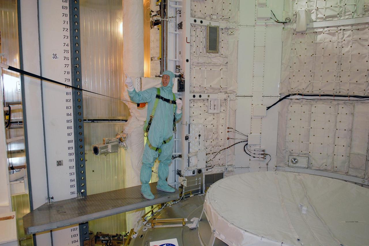 KENNEDY SPACE CENTER, FLA. -- In space shuttle Discovery's payload bay, STS-120 crew members get a close look at the equipment and payloads. Seen here is Mission Specialist Paolo Nespoli, who represents the European Space Agency. He stands on a platform next to the Italian-built U.S. Node 2, named Harmony. The TCDT provides astronauts and ground crews an opportunity to participate in various simulated countdown activities, including equipment familiarization and emergency training. The STS-120 mission will deliver the U.S. Node 2 module, named Harmony, aboard space shuttle Discovery to the International Space Station. Launch of Discovery on mission STS-120 is targeted for Oct. 23 at 11:38 a.m. EDT on a 14-day mission. Photo credit: NASA/Kim Shiflett