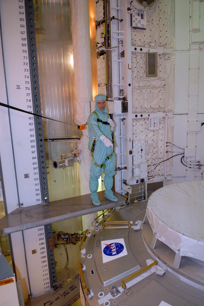 KENNEDY SPACE CENTER, FLA. -- In space shuttle Discovery's payload bay, STS-120 crew members get a close look at the equipment and payloads. Seen here is Mission Specialist Paolo Nespoli, who represents the European Space Agency, pointing to the Italian-built U.S. Node 2, named Harmony. The TCDT provides astronauts and ground crews an opportunity to participate in various simulated countdown activities, including equipment familiarization and emergency training. The STS-120 mission will deliver the U.S. Node 2 module, named Harmony, aboard space shuttle Discovery to the International Space Station. Launch of Discovery on mission STS-120 is targeted for Oct. 23 at 11:38 a.m. EDT on a 14-day mission. Photo credit: NASA/Kim Shiflett