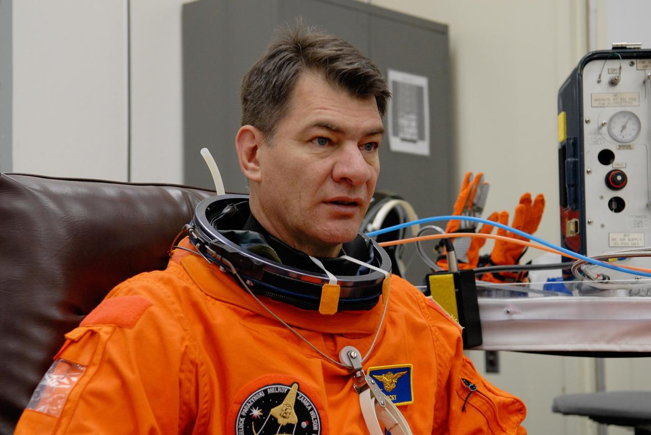 KENNEDY SPACE CENTER, FLA. -- STS-120 Mission Specialist Paolo Nespoli is putting on his launch and entry suit for a simulated launch countdown, part of the prelaunch terminal countdown demonstration test, or TCDT. His name patch reflects the nicknames the crew gave each other for the event. The TCDT provides astronauts and ground crews an opportunity to participate in various launch preparation activities, including equipment familiarization,  emergency training and the simulated countdown. The STS-120 mission will deliver the U.S. Node 2 module, named Harmony, aboard space shuttle Discovery to the International Space Station.  Launch of Discovery on mission STS-120 is targeted for Oct. 23 at 11:38 a.m. EDT on a 14-day mission. Photo credit: NASA/Kim Shiflett