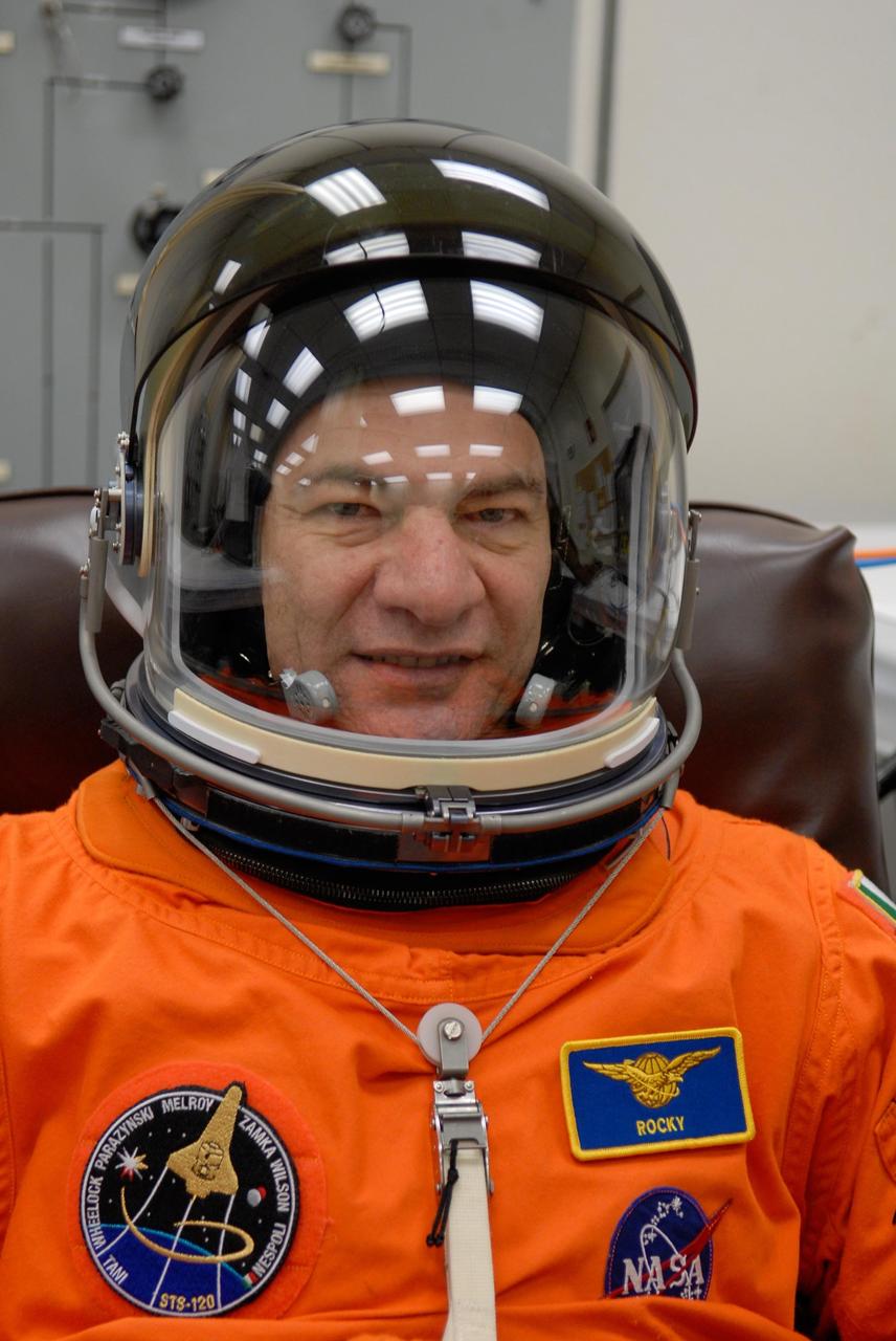 KENNEDY SPACE CENTER, FLA. -- STS-120 Mission Specialist Paolo Nespoli completes suiting up to take part in a simulated launch countdown, part of the prelaunch terminal countdown demonstration test, or TCDT. Nespoli represents the European Space Agency. His name patch reflects the nicknames the crew gave each other for the event. The TCDT provides astronauts and ground crews an opportunity to participate in various launch preparation activities, including equipment familiarization,  emergency training and the simulated countdown. The STS-120 mission will deliver the U.S. Node 2 module, named Harmony, aboard space shuttle Discovery to the International Space Station.  Launch of Discovery on mission STS-120 is targeted for Oct. 23 at 11:38 a.m. EDT on a 14-day mission. Photo credit: NASA/Kim Shiflett