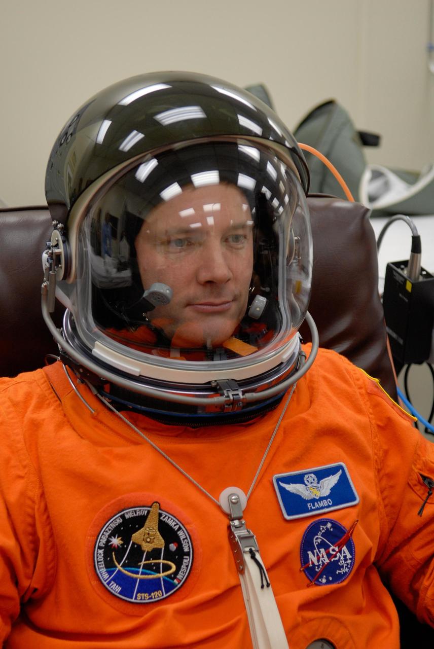 KENNEDY SPACE CENTER, FLA. -- STS-120 Mission Specialist Doug Wheelock completes suiting up to take part in a simulated launch countdown, part of the prelaunch terminal countdown demonstration test, or TCDT. His name patch reflects the nicknames the crew gave each other for the event. The TCDT provides astronauts and ground crews an opportunity to participate in various launch preparation activities, including equipment familiarization,  emergency training and the simulated countdown. The STS-120 mission will deliver the U.S. Node 2 module, named Harmony, aboard space shuttle Discovery to the International Space Station.  Launch of Discovery on mission STS-120 is targeted for Oct. 23 at 11:38 a.m. EDT on a 14-day mission. Photo credit: NASA/Kim Shiflett