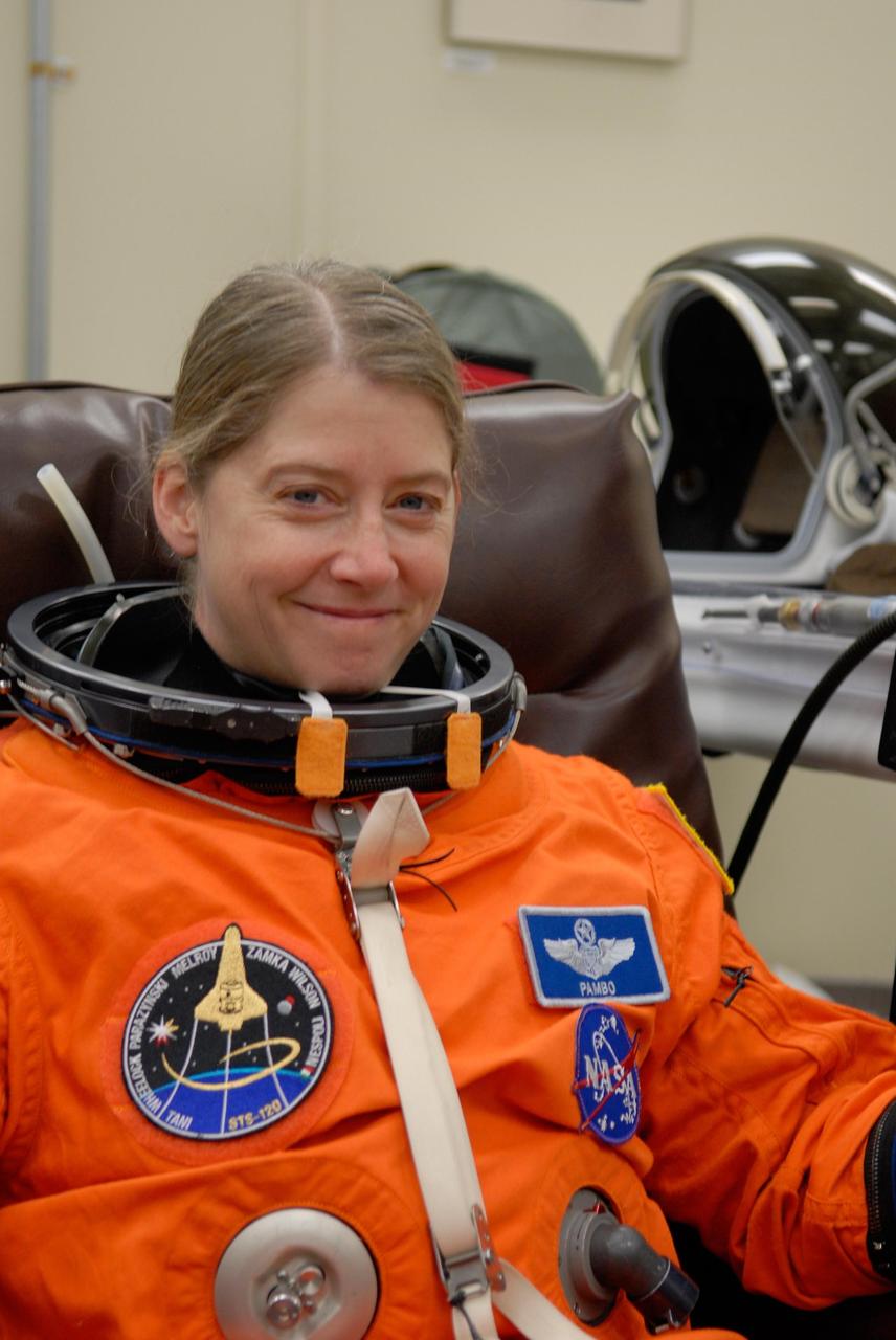KENNEDY SPACE CENTER, FLA. -- STS-120 Commander Pamela Melroy is donning her launch and entry suit to take part in a simulated launch countdown, part of the prelaunch terminal countdown demonstration test, or TCDT.  Her name patch reflects the nicknames the crew gave each other for the event. The TCDT provides astronauts and ground crews an opportunity to participate in various launch preparation activities, including equipment familiarization,  emergency training and the simulated countdown. The STS-120 mission will deliver the U.S. Node 2 module, named Harmony, aboard space shuttle Discovery to the International Space Station.  Launch of Discovery on mission STS-120 is targeted for Oct. 23 at 11:38 a.m. EDT on a 14-day mission. Photo credit: NASA/Kim Shiflett