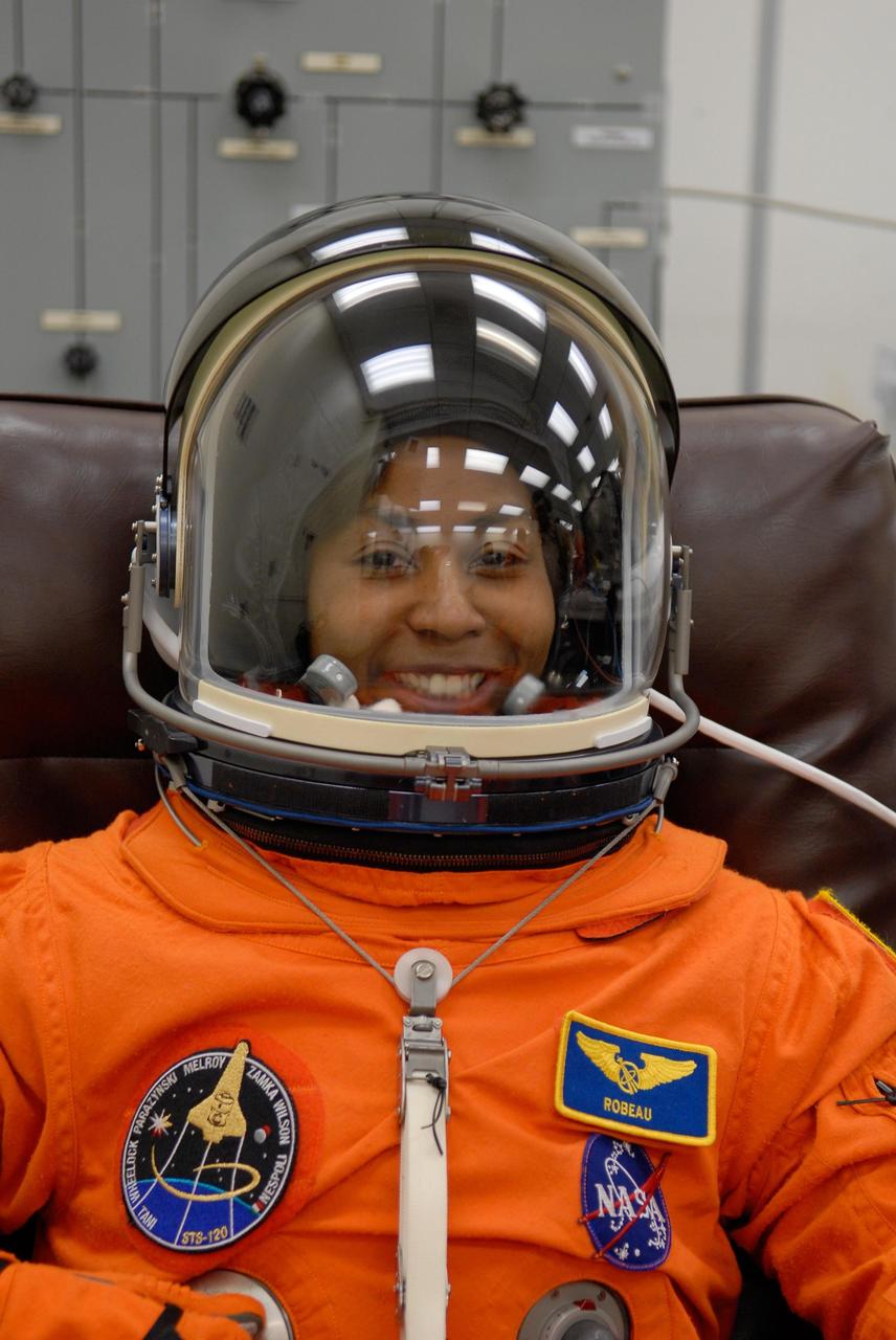 KENNEDY SPACE CENTER, FLA. -- STS-120 Mission Specialist Stephanie Wilson completes suiting up to take part in a simulated launch countdown, part of the prelaunch terminal countdown demonstration test, or TCDT. His name patch reflects the nicknames the crew gave each other for the event. The TCDT provides astronauts and ground crews an opportunity to participate in various launch preparation activities, including equipment familiarization,  emergency training and the simulated countdown. The STS-120 mission will deliver the U.S. Node 2 module, named Harmony, aboard space shuttle Discovery to the International Space Station.  Launch of Discovery on mission STS-120 is targeted for Oct. 23 at 11:38 a.m. EDT on a 14-day mission. Photo credit: NASA/Kim Shiflett