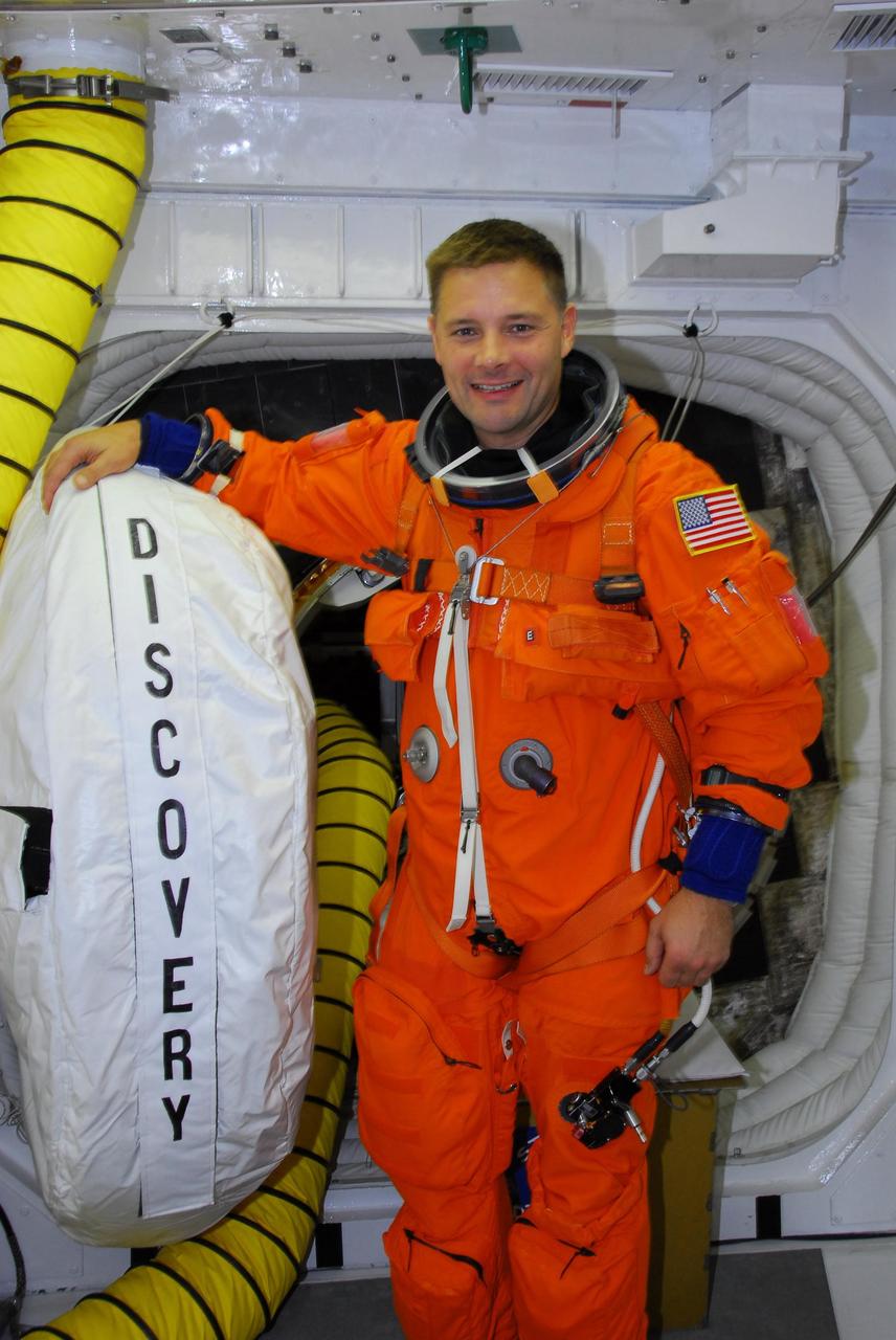 KENNEDY SPACE CENTER, FLA. -- In the white room on Launch Pad 39A, STS-120 Mission Specialist Doug Wheelock is ready to enter space shuttle Discovery for a simulated launch countdown. The countdown is the culmination of the prelaunch terminal countdown demonstration test, or TCDT. The TCDT at NASA's Kennedy Space Center provides astronauts and ground crews an opportunity to participate in various launch preparation activities, including equipment familiarization and emergency training. The STS-120 mission will deliver the U.S. Node 2 module, named Harmony, aboard space shuttle Discovery to the International Space Station. Discovery is targeted to launch on its 14-day mission at 11:38 a.m. EDT on Oct. 23. Photo credit: NASA/George Shelton