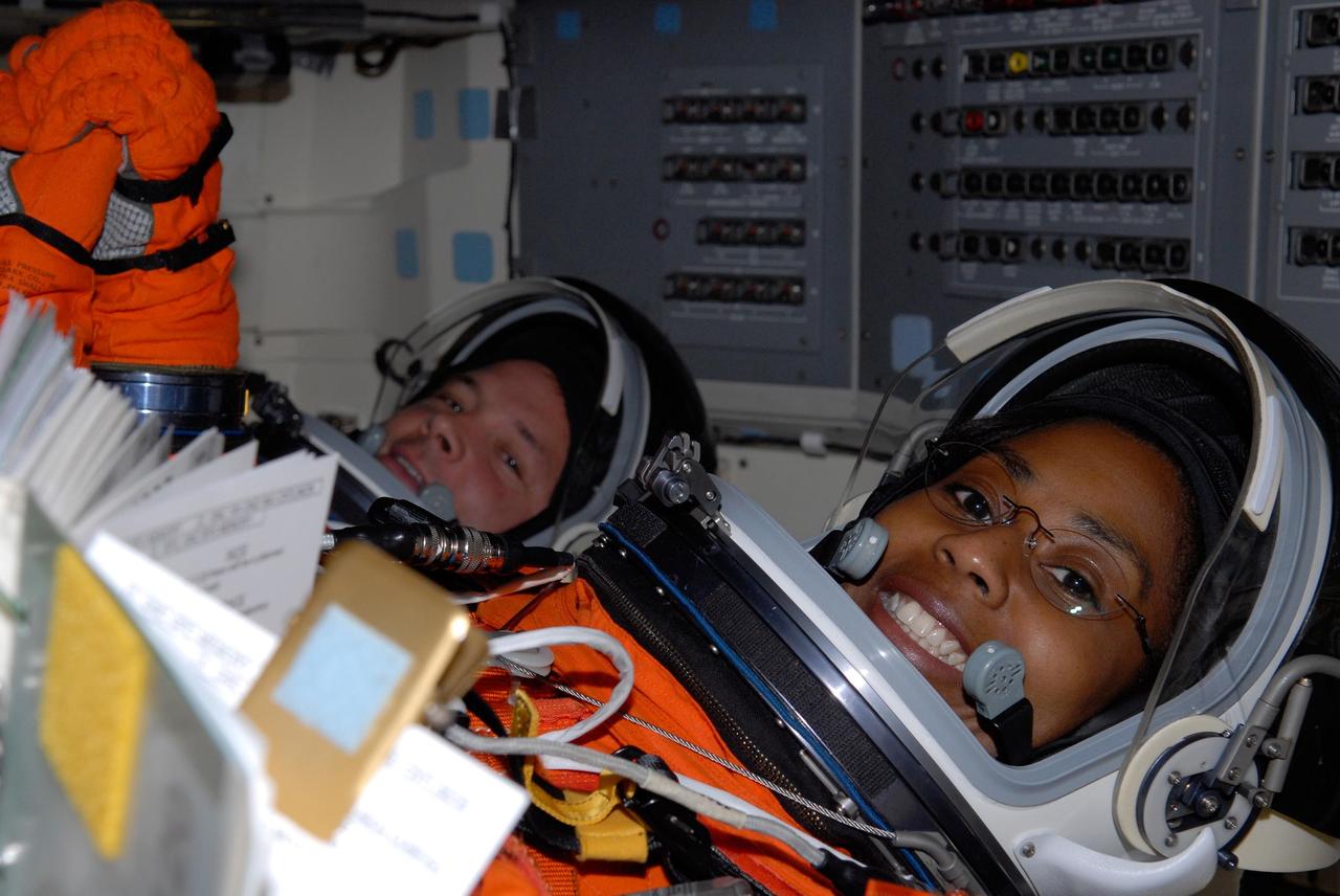 KENNEDY SPACE CENTER, FLA. -- Inside space shuttle Discovery, STS-120 Mission Specialists Doug Wheelock and Stephanie Wilson are in their assigned seats for the simulated launch countdown, culmination of the prelaunch terminal countdown demonstration test, or TCDT. The TCDT at NASA's Kennedy Space Center provides astronauts and ground crews an opportunity to participate in various launch preparation activities, including equipment familiarization and emergency training. The STS-120 mission will deliver the U.S. Node 2 module, named Harmony, aboard space shuttle Discovery to the International Space Station.  Discovery is targeted to launch on its 14-day mission at 11:38 a.m. EDT on Oct. 23. Photo credit: NASA/Kim Shiflett