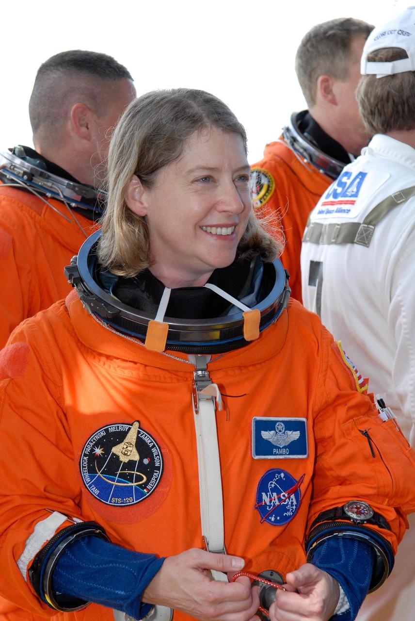 KENNEDY SPACE CENTER, FLA. -- The STS-120 crew gathers at the slidewire basket area on Launch Pad 39A after practicing emergency egress, part of the prelaunch terminal countdown demonstration test, or TCDT.  Seen here in their launch and entry suits are (from left) Pilot George Zamka, Commander Pamela Melroy and Mission Specialist Scott Parazynski.  Their name patches reflect the nicknames the crew gave each other for the event.  The TCDT at NASA's Kennedy Space Center provides astronauts and ground crews an opportunity to participate in various launch preparation activities, including equipment familiarization and emergency training. The STS-120 mission will deliver the U.S. Node 2 module, named Harmony, aboard space shuttle Discovery to the International Space Station.  Discovery is targeted to launch on its 14-day mission at 11:38 a.m. EDT on Oct. 23. Photo credit: NASA/Kim Shiflett