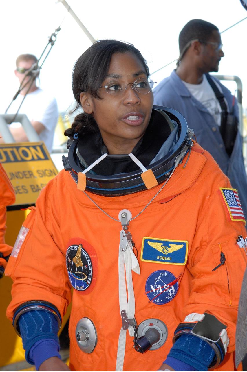 KENNEDY SPACE CENTER, FLA. -- STS-120 Mission Specialist Stephanie Wilson relaxes after practicing emergency egress, part of the prelaunch terminal countdown demonstration test, or TCDT.  Her name patch reflects the nicknames the crew gave each other for the event.  The TCDT at NASA's Kennedy Space Center provides astronauts and ground crews an opportunity to participate in various launch preparation activities, including equipment familiarization and emergency training. The STS-120 mission will deliver the U.S. Node 2 module, named Harmony, aboard space shuttle Discovery to the International Space Station.  Discovery is targeted to launch on its 14-day mission at 11:38 a.m. EDT on Oct. 23. Photo credit: NASA/Kim Shiflett