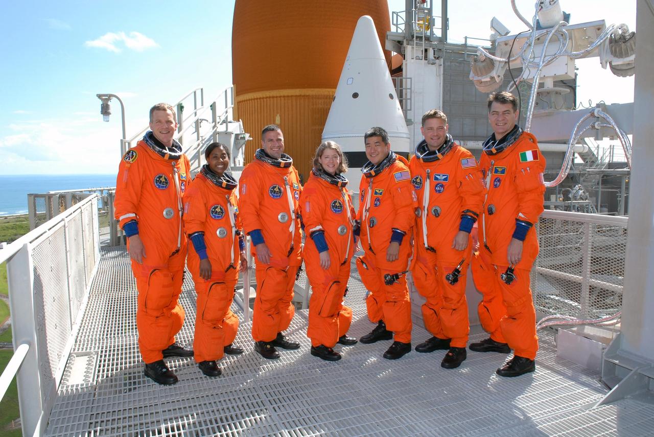KENNEDY SPACE CENTER, FLA. -- Following the successful simulated launch countdown and emergency egress practice, the STS-120 crew gathers for the traditional photo near the top of the fixed service structure.  From left are Mission Specialists Scott Parazynski and Stephanie Wilson, Pilot George Zamka, Commander Pamela Melroy, and Mission Specialists Daniel Tani, Doug Wheelock and Paolo Nespoli, who represents the European Space Agency.   The countdown was the culmination of the prelaunch terminal countdown demonstration test, or TCDT.  The TCDT at NASA's Kennedy Space Center provides astronauts and ground crews an opportunity to participate in various launch preparation activities, including equipment familiarization and emergency training. The STS-120 mission will deliver the U.S. Node 2 module, named Harmony, aboard space shuttle Discovery to the International Space Station.  Discovery is targeted to launch on its 14-day mission at 11:38 a.m. EDT on Oct. 23. Photo credit: NASA/Kim Shiflett