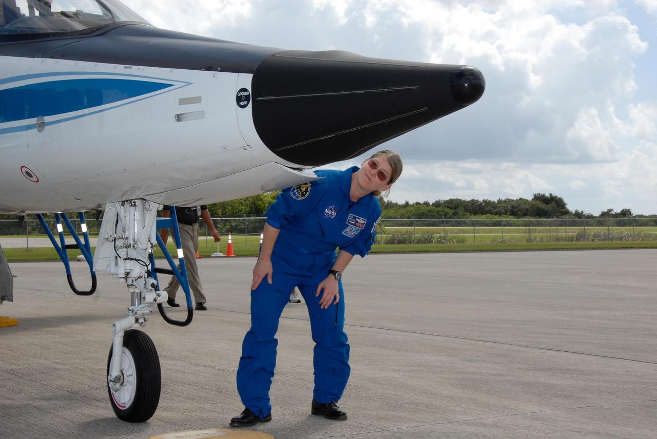 KENNEDY SPACE CENTER, FLA. -- The crew members of space shuttle mission STS-120 prepare for their return to NASA's Johnson Space Center in Houston following three days of terminal countdown demonstration test, or TCDT, activities.  At Kennedy Space Center's Shuttle Landing Facility, Commander Pam Melroy checks the readiness of her T-38 jet aircraft before takeoff. Melroy is the second woman to command a shuttle mission.  The TCDT provides astronauts and ground crews with equipment familiarization, emergency egress training and a simulated launch countdown. The STS-120 mission will deliver the U.S. Node 2 module, named Harmony, aboard space shuttle Discovery to the International Space Station on a 14-day mission.  Discovery's launch is targeted for Oct. 23 at 11:38 a.m. EDT.  Photo credit: NASA/Kim Shiflett