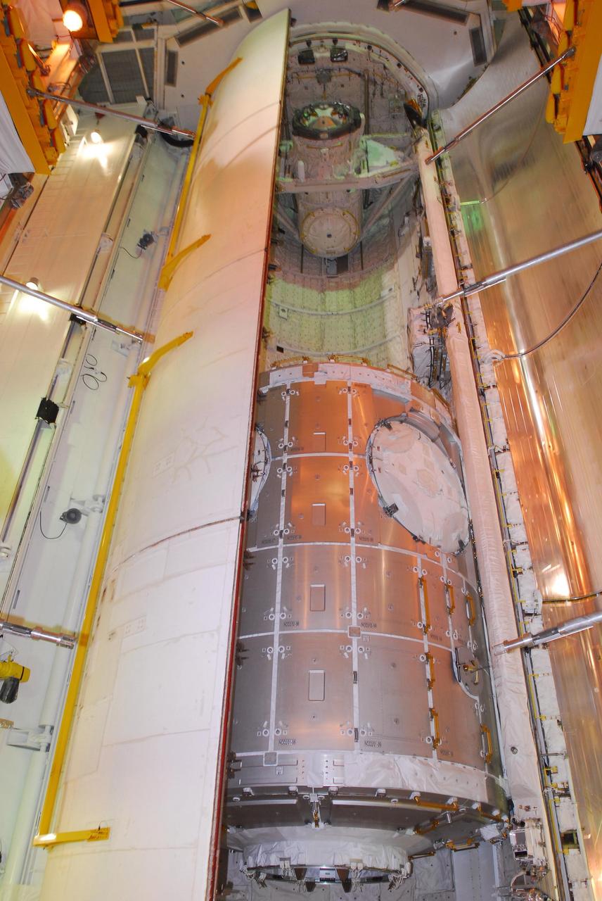 KENNEDY SPACE CENTER, FLA. -- At Launch Pad 39A, space shuttle Discovery's payload bay doors are partially closed around the U.S. Node 2 module, named Harmony.  The name was chosen from an academic competition involving more than 2,200 U. S. students in kindergarten through high school. The module will be delivered to the International Space Station aboard Discovery on the 14-day STS-120 mission.  An orbiter's payload bay door closure at the pad is a milestone signaling that the launch date is near.  Discovery's launch is targeted for Oct. 23 at 11:38 a.m. EDT.  Photo credit: NASA/George Shelton