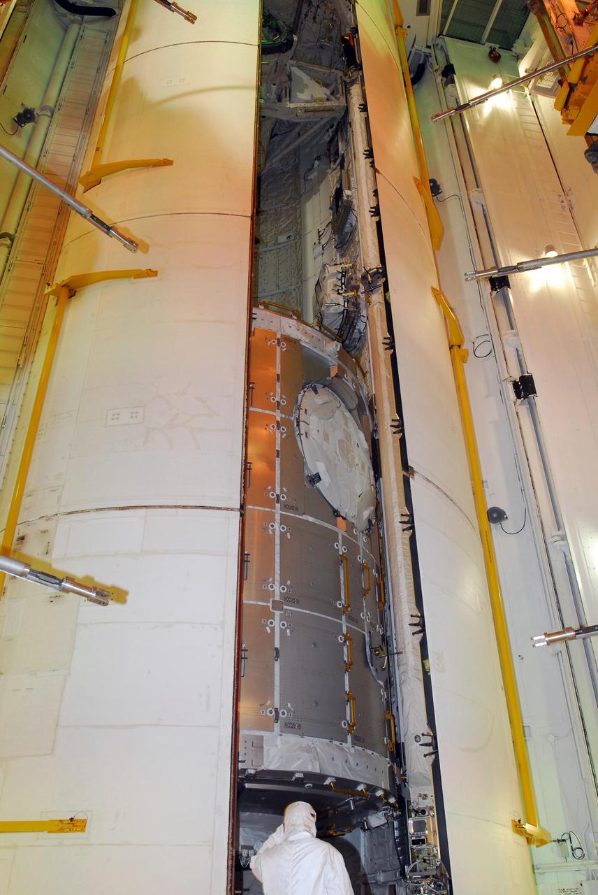 KENNEDY SPACE CENTER, FLA. -- At Launch Pad 39A, space shuttle Discovery's payload bay doors slowly enclose the U.S. Node 2 module, named Harmony. The name was chosen from an academic competition involving more than 2,200 U. S. students in kindergarten through high school. The module will be delivered to the International Space Station aboard Discovery on the 14-day STS-120 mission.  An orbiter's payload bay door closure at the pad is a milestone signaling that the launch date is near.  Discovery's launch is targeted for Oct. 23 at 11:38 a.m. EDT.  Photo credit: NASA/George Shelton