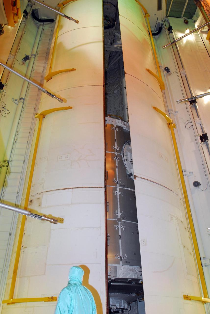 KENNEDY SPACE CENTER, FLA. -- At Launch Pad 39A, space shuttle Discovery's payload bay doors are nearly closed around the U.S. Node 2 module, named Harmony. The name was chosen from an academic competition involving more than 2,200 U. S. students in kindergarten through high school. The module will be delivered to the International Space Station aboard Discovery on the 14-day STS-120 mission.  An orbiter's payload bay door closure at the pad is a milestone signaling that the launch date is near.  Discovery's launch is targeted for Oct. 23 at 11:38 a.m. EDT.  Photo credit: NASA/George Shelton