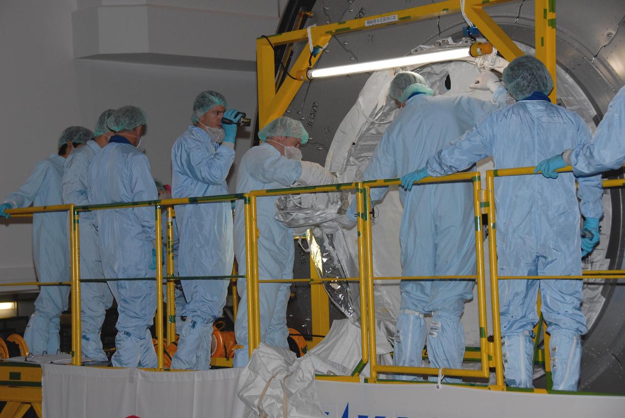KENNEDY SPACE CENTER, FLA. -- In the Space Station Processing Facility at NASA's Kennedy Space Center, members of the STS-123 crew get hands-on experience with the mission payload, the Kibo Experiment Logistics Module Pressurized Section. They are at the center for a crew equipment interface test, which allows familiarization with equipment they will use during the mission. Crew members are Commander Dominic Gorie, Pilot Gregory Johnson and Mission Specialists Richard Linnehan, Takao Doi, Robert Behnken, Gerrett Reisman and Michael Foreman. Doi represents the Japan Aerospace Exploration Agency. Reisman will remain on the space station after the mission as a flight engineer for Expedition 16. STS-123 will carry and install one of the components of the Japanese Experiment Module, or JEM. Known as Kibo, the JEM comprises six components: two research facilities -- the Pressurized Module and Exposed Facility; a Logistics Module attached to each of them; a Remote Manipulator System; and an Inter-Orbit Communication System unit. The various components of JEM will be assembled in space over the course of three space shuttle missions. The first of those three missions, STS-123, will carry the Experiment Logistics Module Pressurized Section aboard the space shuttle Endeavour, targeted for launch in February 2008. Photo credit: NASA/Dimitrios Gerondidakis