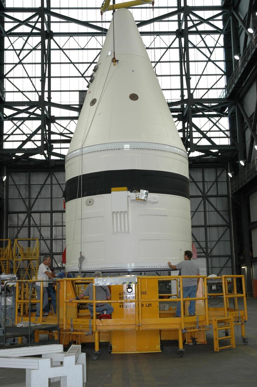KENNEDY SPACE CENTER, FLA. -- In the Vehicle Assembly Building at NASA's Kennedy Space Center, the frustum is lifted from a transporter to be moved onto a stand.  The solid rocket booster segment will be added to the stack for space shuttle Atlantis, launch vehicle for mission STS-122 targeted for a December launch. Atlantis will be carrying the Columbus Laboratory, Europe’s largest contribution to the construction of the International Space Station. It will support scientific and technological research in a microgravity environment. Columbus, a program of ESA, is a multifunctional, pressurized laboratory that will be permanently attached to Node 2 of the space station to carry out experiments in materials science, fluid physics and biosciences, as well as to perform a number of technological applications. Photo credit: NASA/Jack Pfaller