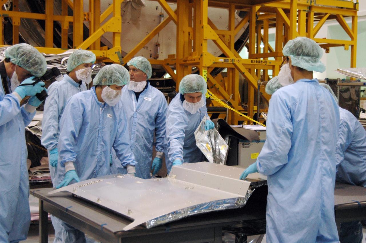 KENNEDY SPACE CENTER, FLA. -- In the Space Station Processing Facility at NASA's Kennedy Space Center, members of the STS-123 crew get hands-on experience with some of the equipment related to the mission. Crew members are Commander Dominic Gorie, Pilot Gregory Johnson and Mission Specialists Richard Linnehan, Takao Doi, Robert Behnken, Gerrett Reisman and Michael Foreman. Doi represents the Japan Aerospace Exploration Agency. Reisman will remain on the space station after the mission as a flight engineer for Expedition 16. STS-123 will carry and install one of the components of the Japanese Experiment Module, or JEM. Known as Kibo, the JEM comprises six components: two research facilities -- the Pressurized Module and Exposed Facility; a Logistics Module attached to each of them; a Remote Manipulator System; and an Inter-Orbit Communication System unit. The various components of JEM will be assembled in space over the course of three space shuttle missions. The first of those three missions, STS-123, will carry the Experiment Logistics Module Pressurized Section aboard the space shuttle Endeavour, targeted for launch in February 2008. Photo credit: NASA/Dimitrios Gerondidakis