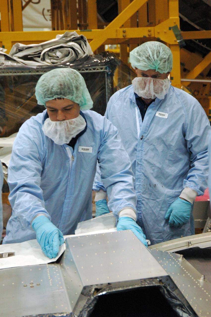 KENNEDY SPACE CENTER, FLA. -- In the Space Station Processing Facility at NASA's Kennedy Space Center, members of the STS-123 crew get hands-on experience with some of the equipment related to the mission. Crew members are Commander Dominic Gorie, Pilot Gregory Johnson and Mission Specialists Richard Linnehan, Takao Doi, Robert Behnken, Gerrett Reisman and Michael Foreman. Doi represents the Japan Aerospace Exploration Agency. Reisman will remain on the space station after the mission as a flight engineer for Expedition 16. STS-123 will carry and install one of the components of the Japanese Experiment Module, or JEM. Known as Kibo, the JEM comprises six components: two research facilities -- the Pressurized Module and Exposed Facility; a Logistics Module attached to each of them; a Remote Manipulator System; and an Inter-Orbit Communication System unit. The various components of JEM will be assembled in space over the course of three space shuttle missions. The first of those three missions, STS-123, will carry the Experiment Logistics Module Pressurized Section aboard the space shuttle Endeavour, targeted for launch in February 2008. Photo credit: NASA/Dimitrios Gerondidakis