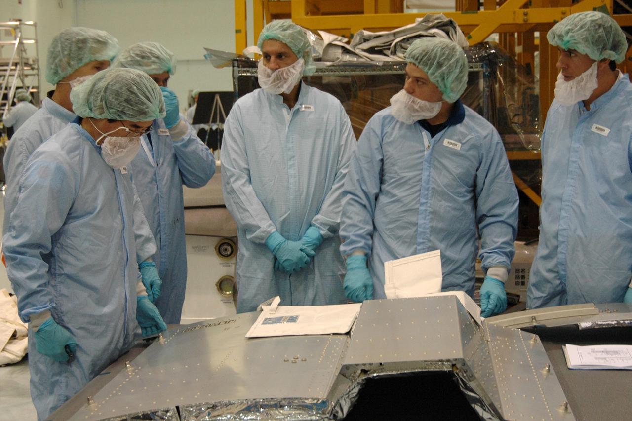 KENNEDY SPACE CENTER, FLA. -- In the Space Station Processing Facility at NASA's Kennedy Space Center, members of the STS-123 crew get hands-on experience with some of the equipment related to the mission. Crew members are Commander Dominic Gorie, Pilot Gregory Johnson and Mission Specialists Richard Linnehan, Takao Doi, Robert Behnken, Gerrett Reisman and Michael Foreman. Doi represents the Japan Aerospace Exploration Agency. Reisman will remain on the space station after the mission as a flight engineer for Expedition 16. STS-123 will carry and install one of the components of the Japanese Experiment Module, or JEM. Known as Kibo, the JEM comprises six components: two research facilities -- the Pressurized Module and Exposed Facility; a Logistics Module attached to each of them; a Remote Manipulator System; and an Inter-Orbit Communication System unit. The various components of JEM will be assembled in space over the course of three space shuttle missions. The first of those three missions, STS-123, will carry the Experiment Logistics Module Pressurized Section aboard the space shuttle Endeavour, targeted for launch in February 2008. Photo credit: NASA/Dimitrios Gerondidakis