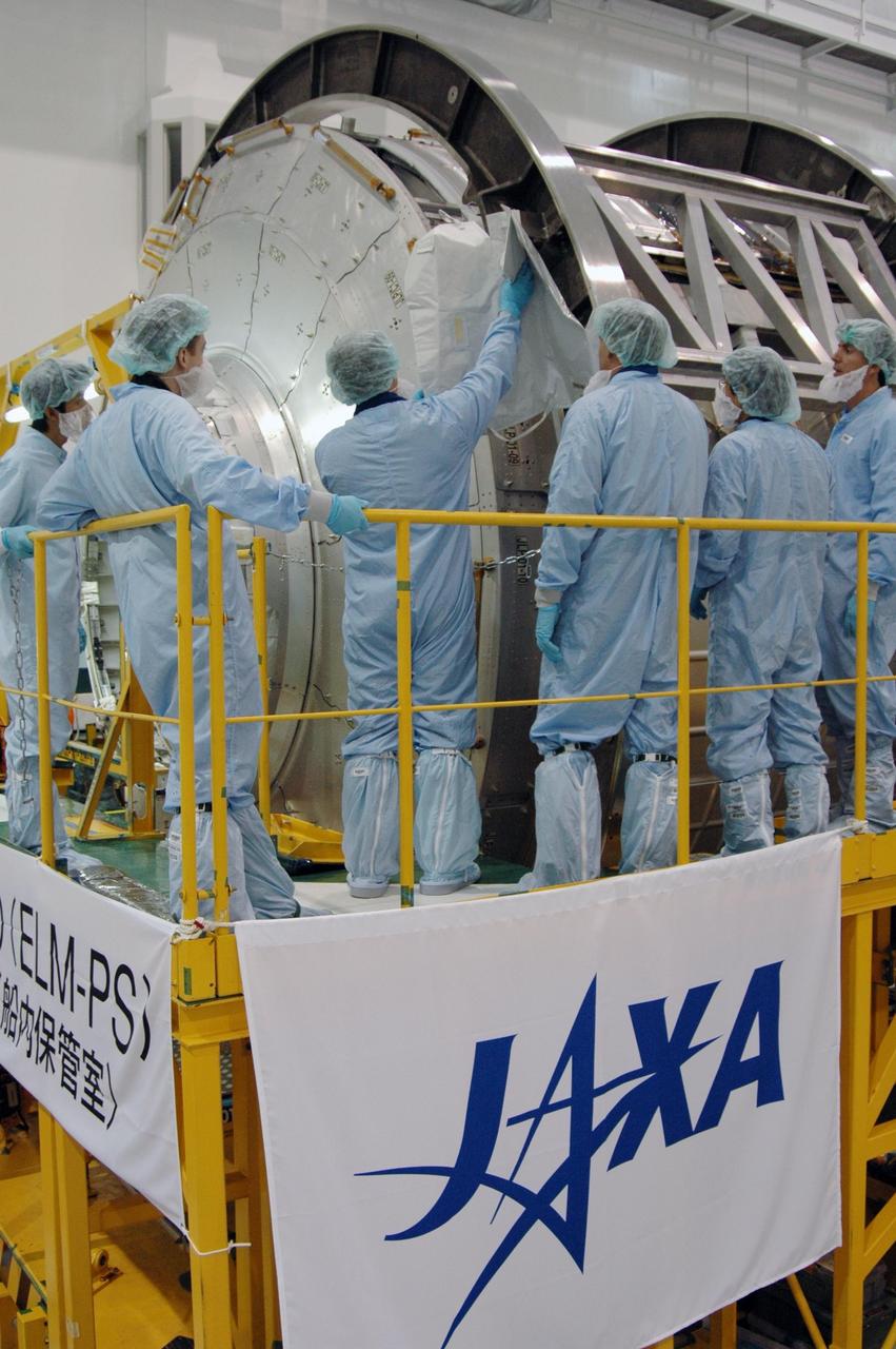 KENNEDY SPACE CENTER, FLA. -- In the Space Station Processing Facility at NASA's Kennedy Space Center, members of the STS-123 crew learn more about the mission payload, the Kibo Experiment Logistics Module Pressurized Section. Crew members are Commander Dominic Gorie, Pilot Gregory Johnson and Mission Specialists Richard Linnehan, Takao Doi, Robert Behnken, Gerrett Reisman and Michael Foreman. Doi represents the Japan Aerospace Exploration Agency. Reisman will remain on the space station after the mission as a flight engineer for Expedition 16. STS-123 will carry and install one of the components of the Japanese Experiment Module, or JEM. Known as Kibo, the JEM comprises six components: two research facilities -- the Pressurized Module and Exposed Facility; a Logistics Module attached to each of them; a Remote Manipulator System; and an Inter-Orbit Communication System unit. The various components of JEM will be assembled in space over the course of three space shuttle missions. The first of those three missions, STS-123, will carry the Experiment Logistics Module Pressurized Section aboard the space shuttle Endeavour, targeted for launch in February 2008. Photo credit: NASA/Dimitrios Gerondidakis