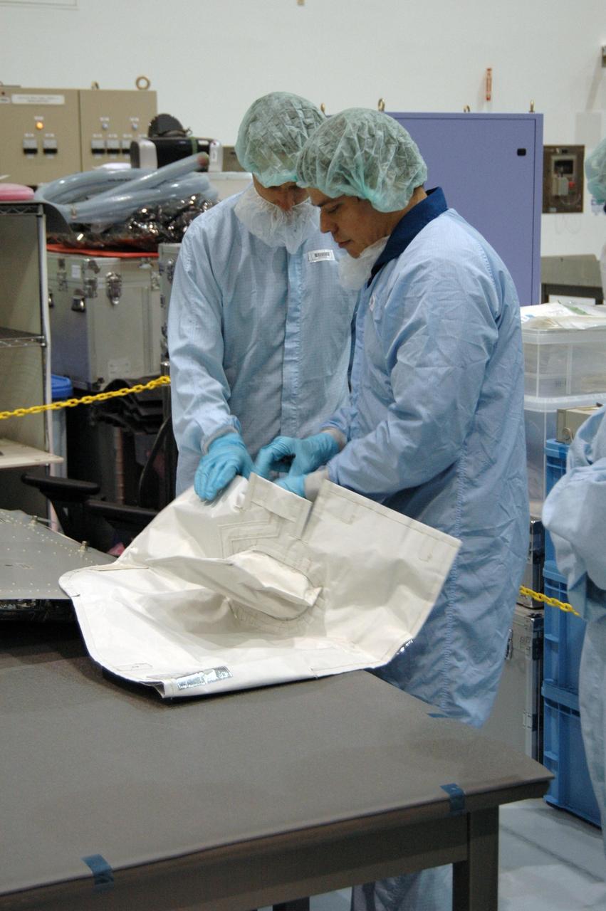 KENNEDY SPACE CENTER, FLA. -- In the Space Station Processing Facility at NASA's Kennedy Space Center, members of the STS-123 crew get hands-on experience with some of the equipment related to the mission. Crew members are Commander Dominic Gorie, Pilot Gregory Johnson and Mission Specialists Richard Linnehan, Takao Doi, Robert Behnken, Gerrett Reisman and Michael Foreman. Doi represents the Japan Aerospace Exploration Agency. Reisman will remain on the space station after the mission as a flight engineer for Expedition 16. STS-123 will carry and install one of the components of the Japanese Experiment Module, or JEM. Known as Kibo, the JEM comprises six components: two research facilities -- the Pressurized Module and Exposed Facility; a Logistics Module attached to each of them; a Remote Manipulator System; and an Inter-Orbit Communication System unit. The various components of JEM will be assembled in space over the course of three space shuttle missions. The first of those three missions, STS-123, will carry the Experiment Logistics Module Pressurized Section aboard the space shuttle Endeavour, targeted for launch in February 2008. Photo credit: NASA/Dimitrios Gerondidakis