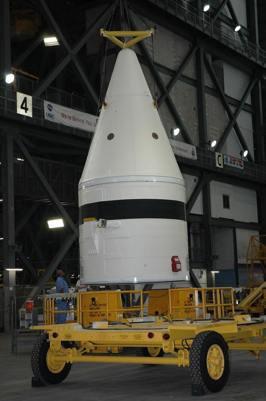 KENNEDY SPACE CENTER, FLA. -- In the Vehicle Assembly Building at NASA's Kennedy Space Center, technicians begin to lift a frustum from a stand in the transfer aisle.  The solid rocket booster segment is being moved into a high bay where it will be added to the stack being prepared for space shuttle mission STS-122, targeted for launch in December. On this mission, Atlantis will carry the Columbus Laboratory, the European Space Agency's largest contribution to the International Space Station.  Columbus is a multifunctional, pressurized laboratory that will be permanently attached to U.S. Node 2, also called Harmony, to carry out experiments in materials science, fluid physics and biosciences, as well as to support a number of technological applications. Photo credit: NASA/Jack Pfaller