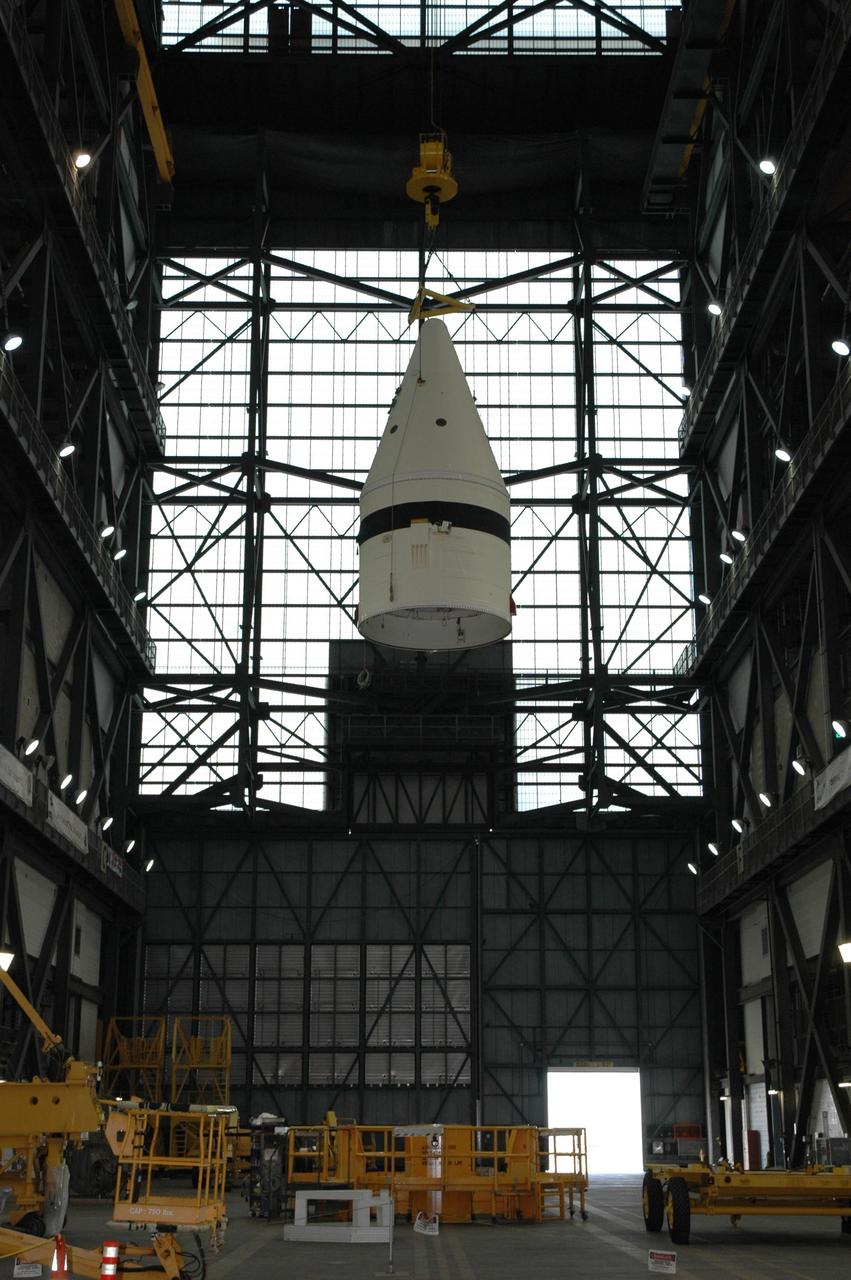 KENNEDY SPACE CENTER, FLA. -- In the Vehicle Assembly Building at NASA's Kennedy Space Center, a crane lifts a frustum high above the transfer aisle.  The solid rocket booster segment is being moved into a high bay where it will be added to the stack being prepared for space shuttle mission STS-122, targeted for launch in December. On this mission, Atlantis will carry the Columbus Laboratory, the European Space Agency's largest contribution to the International Space Station.  Columbus is a multifunctional, pressurized laboratory that will be permanently attached to U.S. Node 2, also called Harmony, to carry out experiments in materials science, fluid physics and biosciences, as well as to support a number of technological applications. Photo credit: NASA/Jack Pfaller