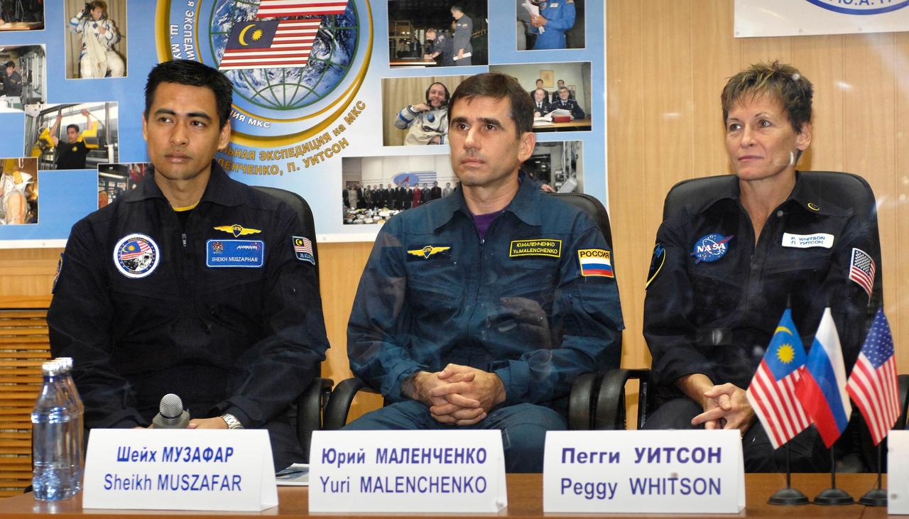 Baikonur, Kazakhstan -- Flight Engineer and Soyuz Commander Yuri Malenchenko and Malaysian Spaceflight Participant Sheikh Muszaphar Shukor are protected behind glass during the State Commission meeting and press conference Oct. 9, 2007, at the Baikonur Cosmodrome in Kazakhstan. The crew is in preparation for their launch to the International Space Station Oct. 10 in their Soyuz TMA-11 spacecraft. Whitson and Malenchenko will spend six months on the station while Shukor will return to Earth Oct. 21 with two of the Expedition 15 crewmembers currently on the complex.  Photo credit: NASA/Bill Ingalls