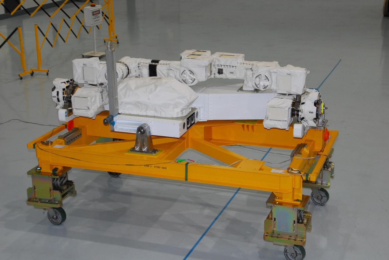 KENNEDY SPACE CENTER, FLA. -- In the Space Station Processing Facility at NASA's Kennedy Space Center, the starboard arm of the Special Purpose Dexterous Manipulator, known as Dextre, is ready to be installed on the base. Dextre is a sophisticated dual-armed robot, which is part of Canada's contribution to the International Space Station ISS. Along with Canadarm2, whose technical name is the Space Station Remote Manipulator System, and a moveable work platform called the Mobile Base System, these three elements form a robotic system called the Mobile Servicing System, or MSS. The three components have been designed to work together or independently. Dextre is part of the payload scheduled on mission STS-123, targeted to launch Feb. 14. Photo credit: NASA/George Shelton