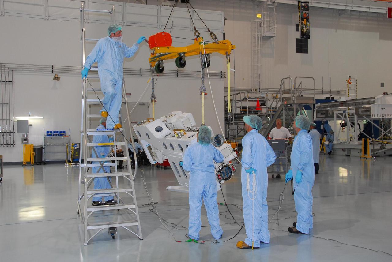 KENNEDY SPACE CENTER, FLA. -- In the Space Station Processing Facility at NASA's Kennedy Space Center, technicians begin raising the starboard arm of the Special Purpose Dexterous Manipulator, known as Dextre, for its move across the facility. The arm will be installed on the base. Dextre is a sophisticated dual-armed robot, which is part of Canada's contribution to the International Space Station ISS. Along with Canadarm2, whose technical name is the Space Station Remote Manipulator System, and a moveable work platform called the Mobile Base System, these three elements form a robotic system called the Mobile Servicing System, or MSS. The three components have been designed to work together or independently. Dextre is part of the payload scheduled on mission STS-123, targeted to launch Feb. 14. Photo credit: NASA/George Shelton