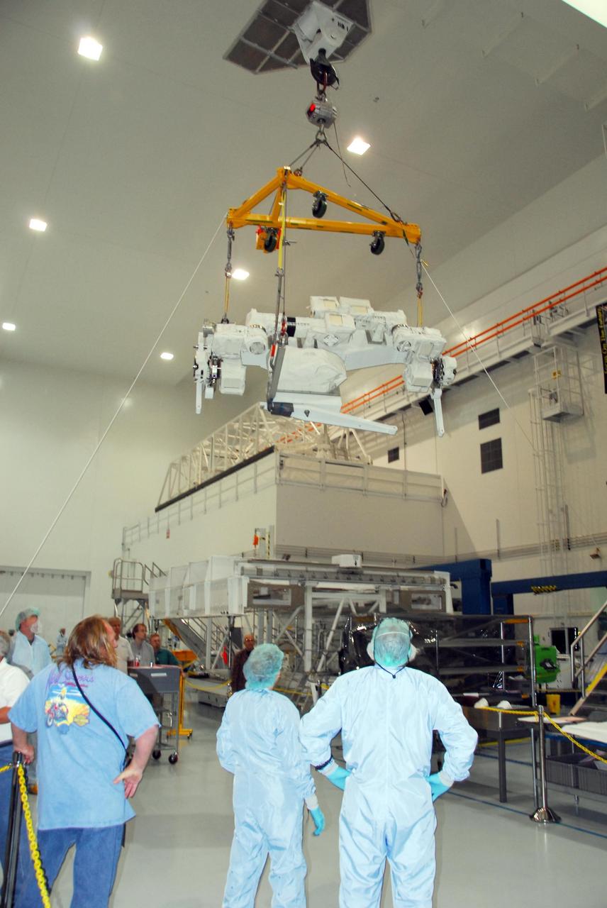 KENNEDY SPACE CENTER, FLA. -- In the Space Station Processing Facility at NASA's Kennedy Space Center, the starboard arm of the Special Purpose Dexterous Manipulator, known as Dextre, is moved across the facility. The arm will be installed on the base. Dextre is a sophisticated dual-armed robot, which is part of Canada's contribution to the International Space Station (ISS). Along with Canadarm2, whose technical name is the Space Station Remote Manipulator System, and a moveable work platform called the Mobile Base System, these three elements form a robotic system called the Mobile Servicing System, or MSS. The three components have been designed to work together or independently. Dextre is part of the payload scheduled on mission STS-123, targeted to launch Feb. 14. Photo credit: NASA/George Shelton