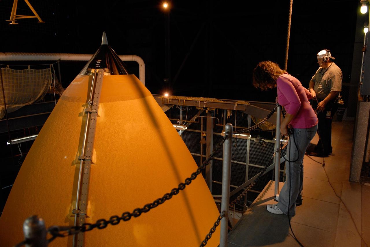 KENNEDY SPACE CENTER, FLA. -- In the Vehicle Assembly Building at NASA's Kennedy Space Center, United Space Alliance technicians get ready to lower the external tank to be mated with the solid rocket boosters on the mobile launcher platform. The boosters-tank configuration will be used on space shuttle Atlantis for mission STS-122, which is targeted for launch on Dec. 6. Photo credit: Kim Shiflett