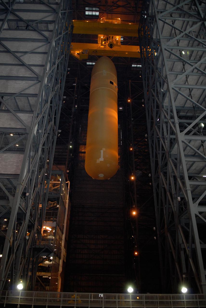 KENNEDY SPACE CENTER, FLA. -- In the Vehicle Assembly Building at NASA's Kennedy Space Center, the external tank is lowered toward the solid rocket boosters on the mobile launcher platform below. After mating, the boosters-tank configuration will be used on space shuttle Atlantis for mission STS-122, which is targeted for launch on Dec. 6. Photo credit: Kim Shiflett