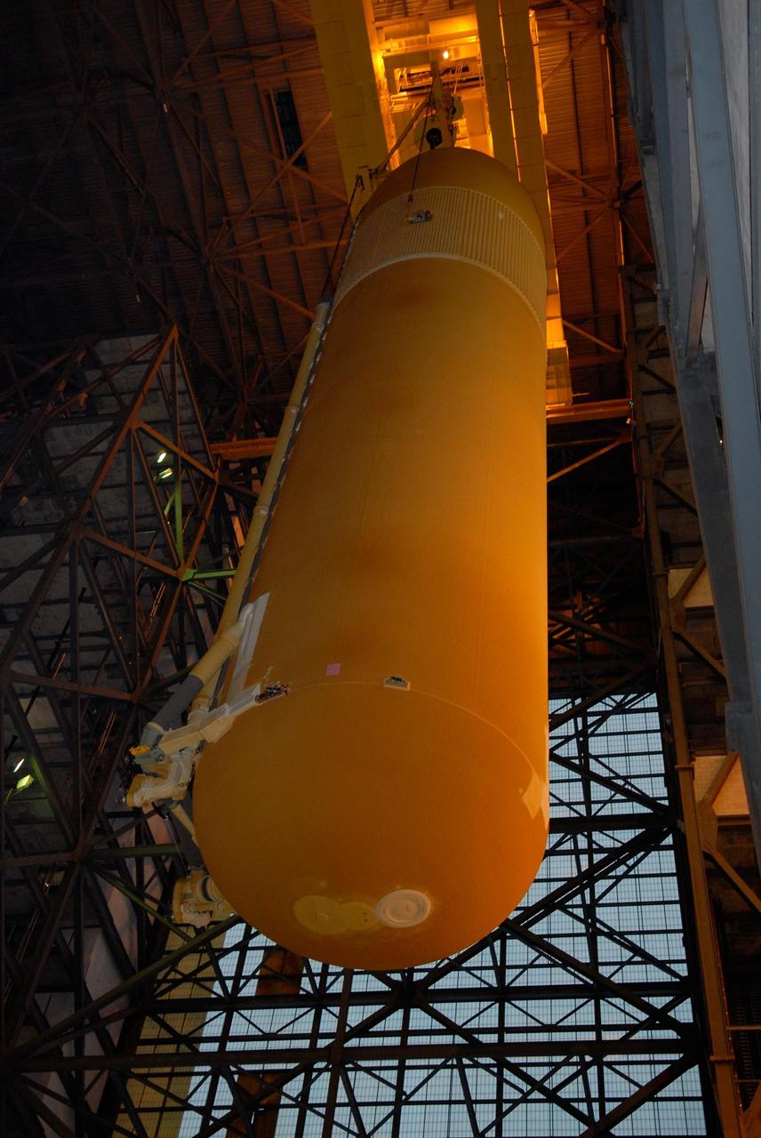 KENNEDY SPACE CENTER, FLA. -- In the Vehicle Assembly Building at NASA's Kennedy Space Center, the external tank is lowered toward the solid rocket boosters on the mobile launcher platform below. Visible on the bottom is an orbiter aft attachment. After mating, the boosters-tank configuration will be used on space shuttle Atlantis for mission STS-122, which is targeted for launch on Dec. 6. Photo credit: Kim Shiflett