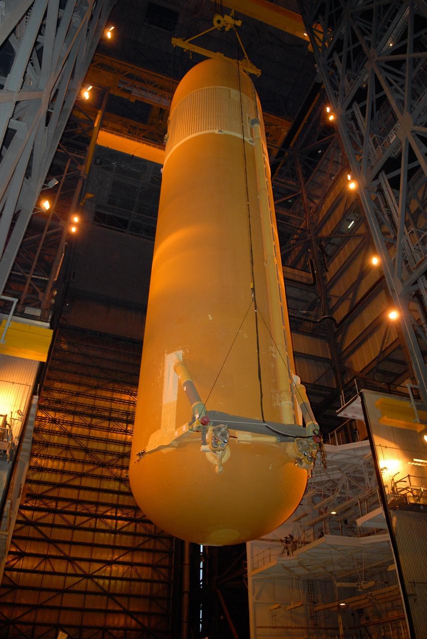 KENNEDY SPACE CENTER, FLA. -- In the Vehicle Assembly Building at NASA's Kennedy Space Center, the external tank is lowered toward the solid rocket boosters on the mobile launcher platform below. Visible on the bottom are the orbiter aft attachments. After mating, the boosters-tank configuration will be used on space shuttle Atlantis for mission STS-122, which is targeted for launch on Dec. 6. Photo credit: Kim Shiflett