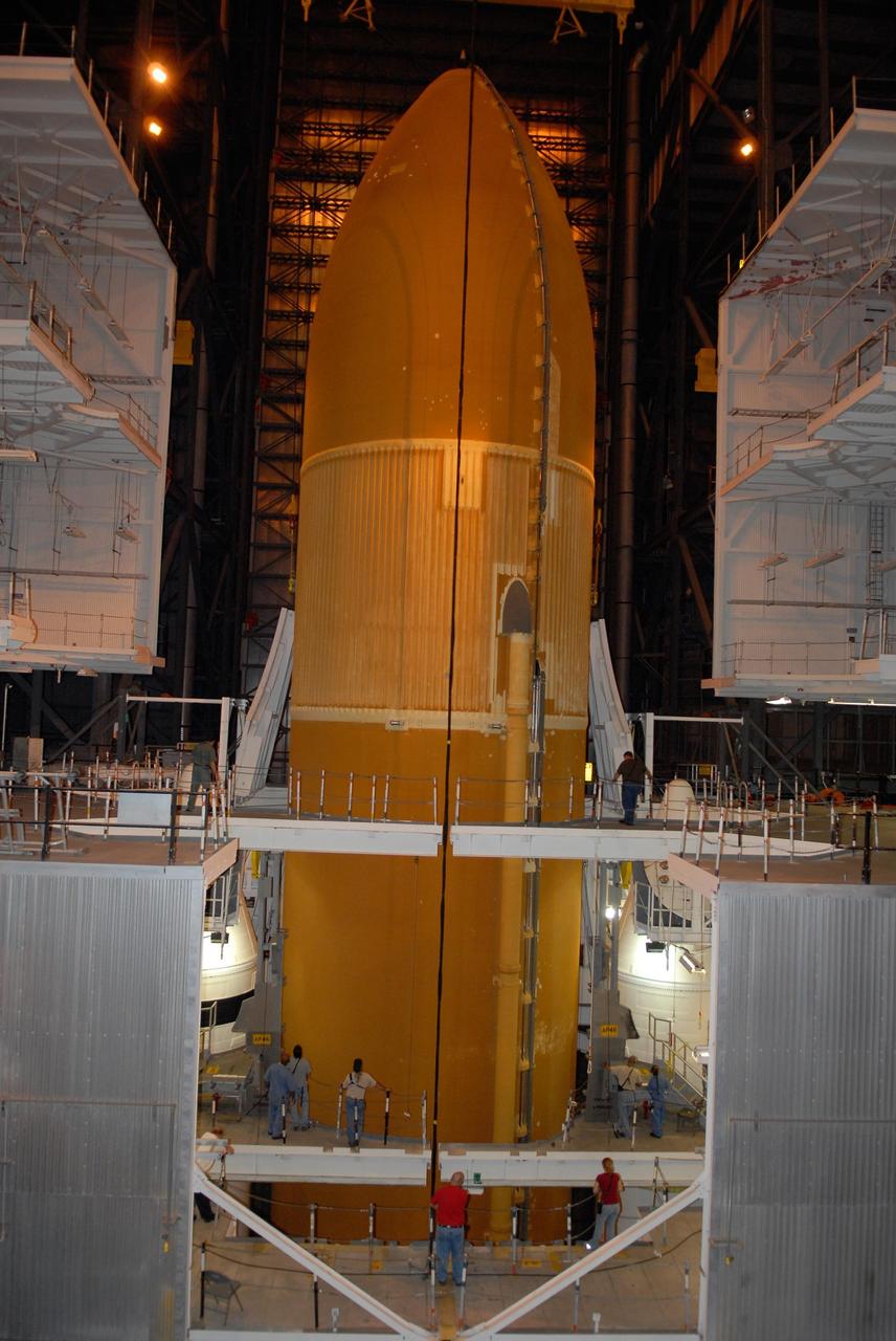 KENNEDY SPACE CENTER, FLA. -- In the Vehicle Assembly Building at NASA's Kennedy Space Center, the external tank is lowered between the solid rocket boosters on the mobile launcher platform below. After mating, the boosters-tank configuration will be used on space shuttle Atlantis for mission STS-122, which is targeted for launch on Dec. 6. Photo credit: Kim Shiflett