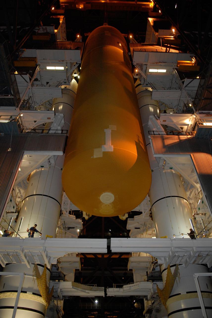 KENNEDY SPACE CENTER, FLA. -- In the Vehicle Assembly Building at NASA's Kennedy Space Center, the external tank is lowered between the solid rocket boosters on the mobile launcher platform below. After mating, the boosters-tank configuration will be used on space shuttle Atlantis for mission STS-122, which is targeted for launch on Dec. 6. Photo credit: Kim Shiflett