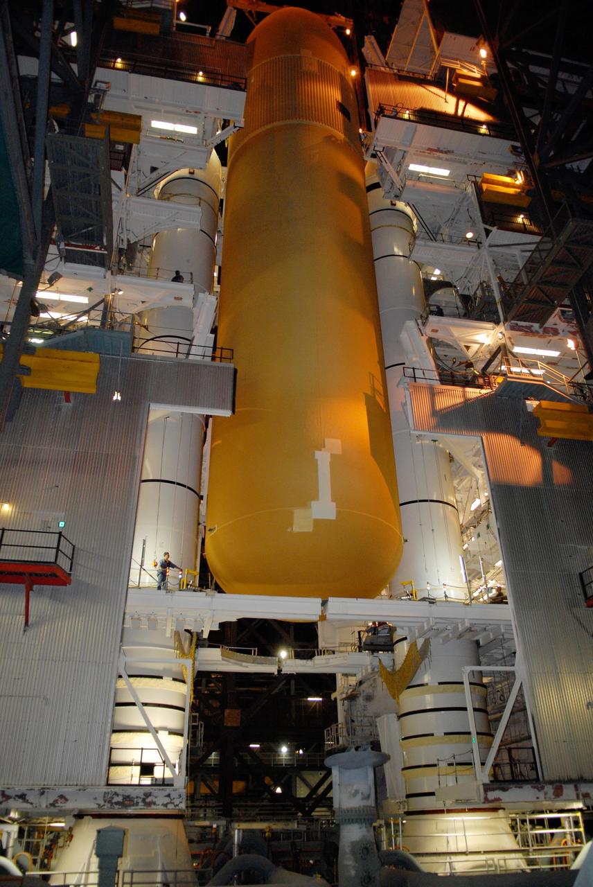 KENNEDY SPACE CENTER, FLA. -- In the Vehicle Assembly Building at NASA's Kennedy Space Center, the external tank is lowered between the solid rocket boosters on the mobile launcher platform below. After mating, the boosters-tank configuration will be used on space shuttle Atlantis for mission STS-122, which is targeted for launch on Dec. 6. Photo credit: Kim Shiflett