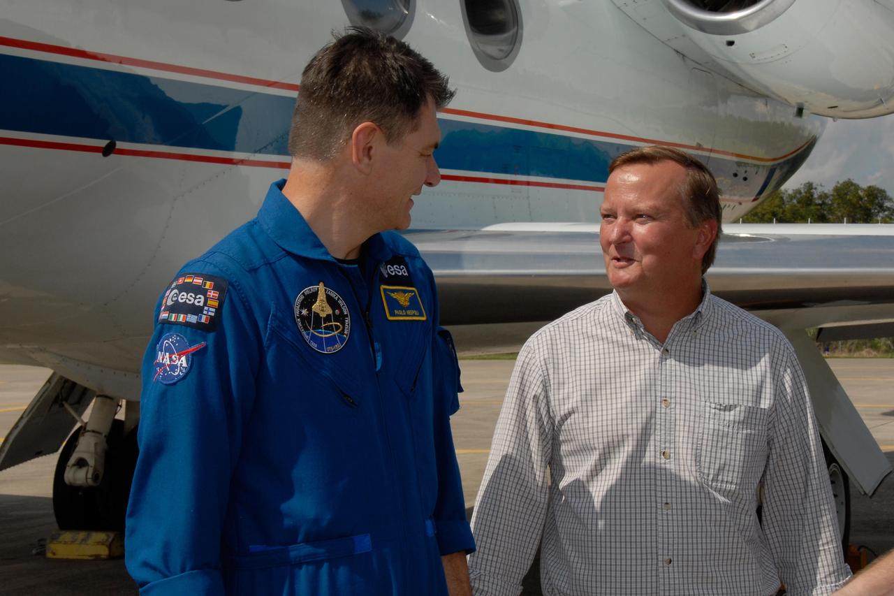 KENNEDY SPACE CENTER, FLA. --  STS-120 Mission Specialist Paolo Nespoli (left) talks with Shuttle Launch Director Mike Leinbach after the crew's arrival at NASA's Kennedy Space Center.  Nespoli represents the European Space Agency.   The crew has returned to Kennedy to prepare for launch aboard space shuttle Discovery at 11:38 a.m. EDT on Oct. 23.  The mission will be the 23rd shuttle flight to the International Space Station, delivering the Italian-built U.S. Node 2, called Harmony.  The 14-day mission includes five spacewalks -- four by shuttle crew members and one by the station’s Expedition 16 crew -- to install Harmony and move the P6 solar arrays to their permanent position and deploy them.  Discovery is expected to complete its mission and return home at 4:47 a.m. EST on Nov. 6.   Photo credit: NASA/Kim Shiflett