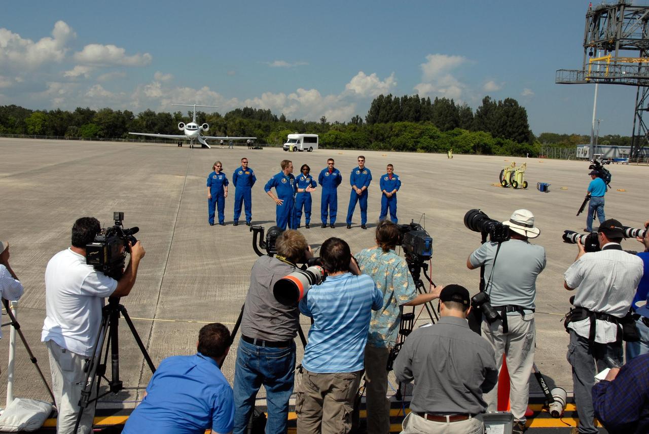 KENNEDY SPACE CENTER, FLA. -- At the Shuttle Landing Facility of NASA's Kennedy Space Center, STS-120 crew members talk to the media and other spectators who greeted their arrival. From left are Commander Pamela Melroy, Pilot George Zamka and Mission Specialists Scott Parazynski (at microphone), Stephanie Wilson, Doug Wheelock, Paolo Nespoli and Daniel Tani. Nespoli represents the European Space Agency. Tani will be remaining on the International Space Station to join the Expedition 16 crew after the mission is complete. The crew has returned to Kennedy to prepare for launch aboard space shuttle Discovery at 11:38 a.m. EDT on Oct. 23. The mission will be the 23rd shuttle flight to the International Space Station, delivering the Italian-built U.S. Node 2, called Harmony. The 14-day mission includes five spacewalks -- four by shuttle crew members and one by the station’s Expedition 16 crew -- to install Harmony and move the P6 solar arrays to their permanent position and deploy them. Discovery is expected to complete its mission and return home at 4:47 a.m. EST on Nov. 6. Photo credit: NASA/Kim Shiflett