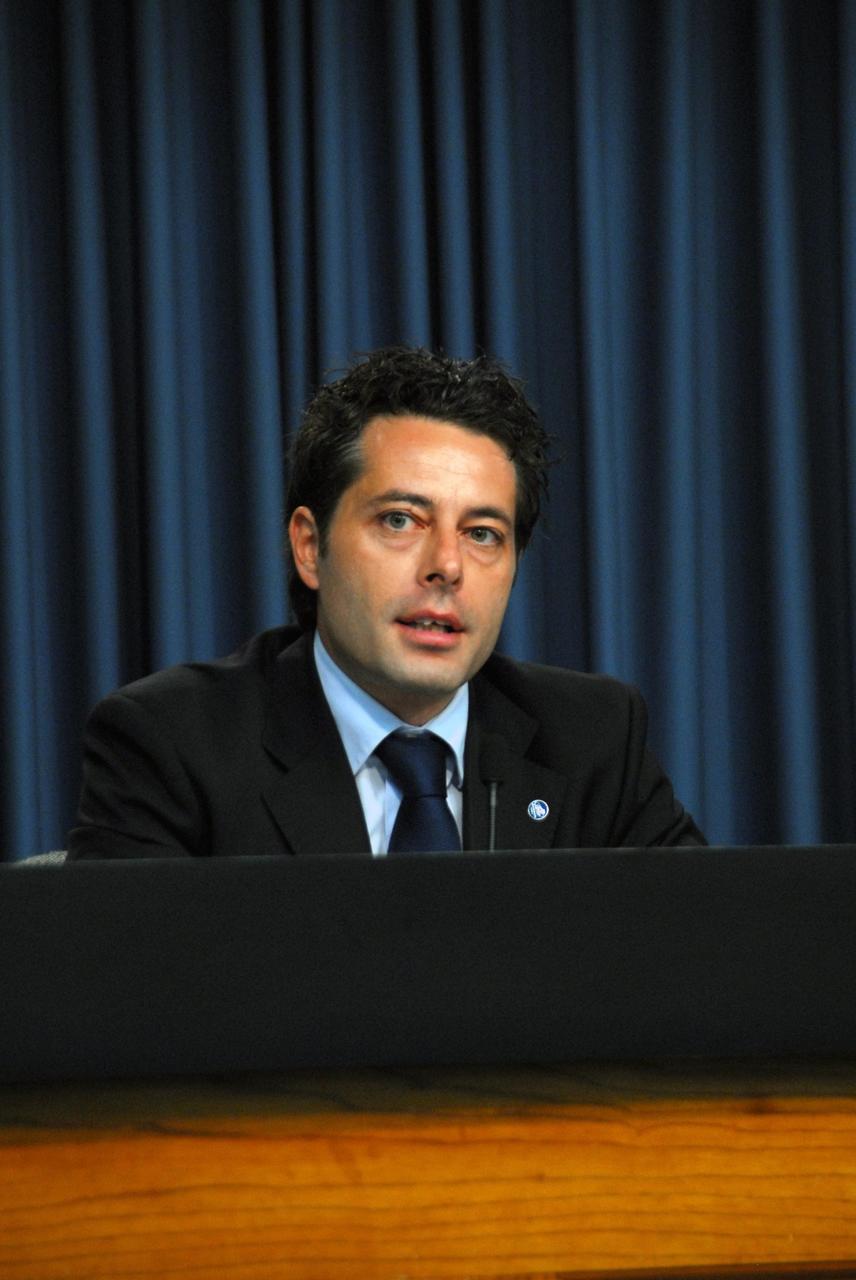 KENNEDY SPACE CENTER, FLA. -- Mauro Piermaria, the ESPERIA mission manager for ASI, the Italian Space Agency, answers questions from the media during a news briefing on the launch readiness of space shuttle mission STS-120.  The STS-120 mission will be the 23rd shuttle flight to the International Space Station, delivering the Italian-built U.S. Node 2, called Harmony. The seven-member crew includes ESA astronaut Paolo Nespoli from Italy. The 14-day mission includes five spacewalks -- four by shuttle crew members and one by the station's Expedition 16 crew -- to install Harmony and move the P6 solar arrays to their permanent position and deploy them. Launch aboard space shuttle Discovery is planned for 11:38 a.m. EDT Oct. 23, and Discovery is scheduled to complete its mission and return home on Nov. 6.  Photo credit: NASA/George Shelton