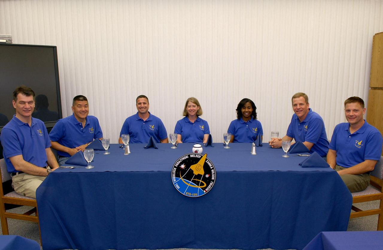 KENNEDY SPACE CENTER, FLA. --  At NASA's Kennedy Space Center, the STS-120 crew members have gathered for the traditional breakfast before launch on space shuttle Discovery to the International Space Station.  Around the table, from left, are Mission Specialists Paolo Nespoli and Daniel Tani, Pilot George Zamka, Commander Pamela Melroy and Mission Specialists Stephanie Wilson, Scott Parazynski and Doug Wheelock.  Melroy is only the second woman to command a shuttle mission.   Discovery is scheduled for liftoff from Launch Pad 39A at 11:38 a.m. EDT.  The mission will be the 23rd assembly flight to the space station and the 34th flight for Discovery.  Payload on the mission is the Italian-built U.S. Node 2, called Harmony.  During the 14-day mission, the crew will install Harmony and move the P6 solar arrays to their permanent position and deploy them.  Discovery is expected to complete its mission and return home at 4:47 a.m. EST on Nov. 6. Photo credit: NASA/Kim Shiflett