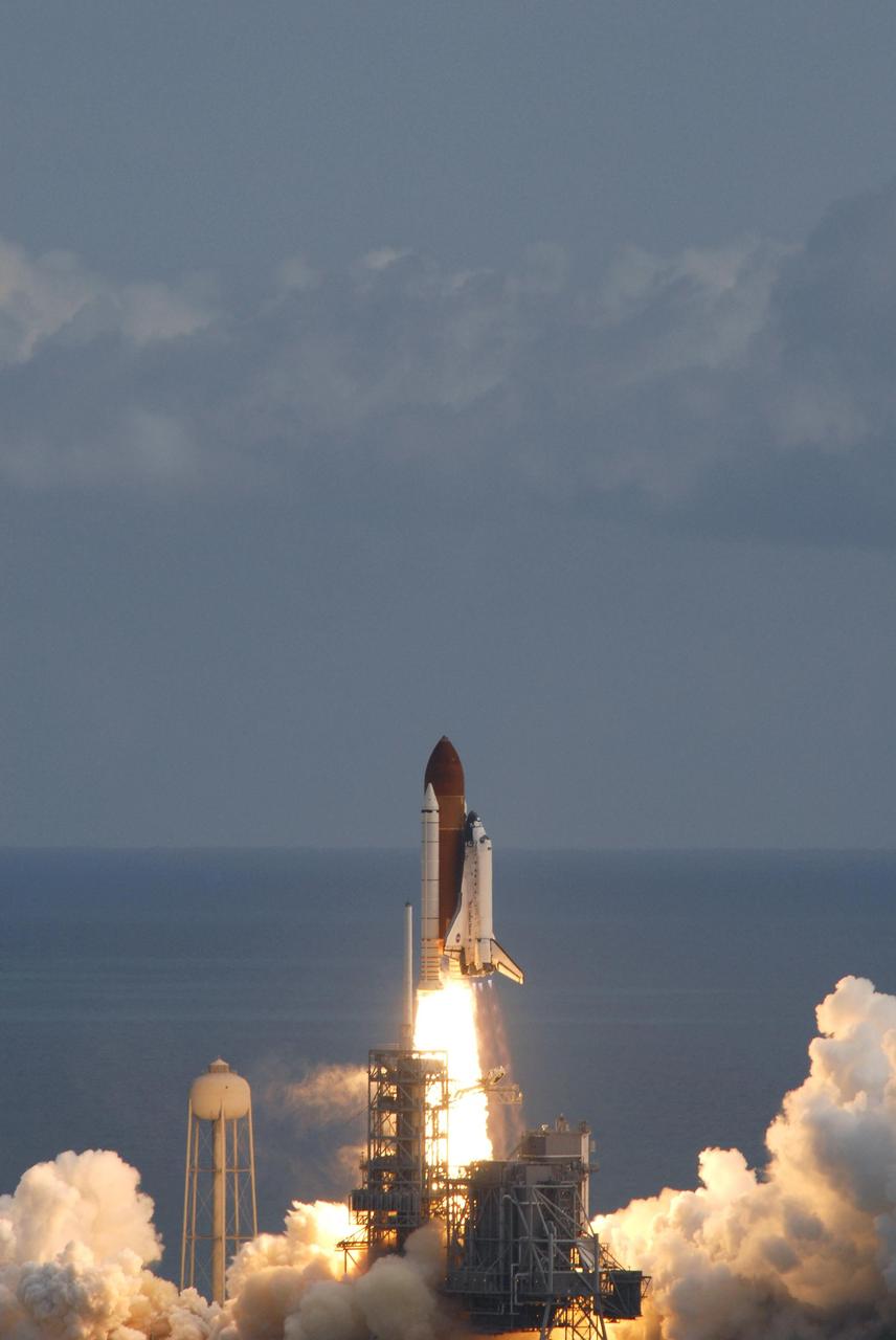KENNEDY SPACE CENTER, FLA. -- Atop a pillar of fire, space shuttle Discovery roars into the sky toward space.  Clouds of smoke and steam roll across the seaside launch pad at NASA's Kennedy Space Center.  Liftoff was on time at 11:38:19 a.m. EDT.  Discovery carries the Italian-built U.S. Node 2, called Harmony.  During the 14-day STS-120 mission, the crew will install Harmony and move the P6 solar arrays to their permanent position and deploy them. Discovery is expected to complete its mission and return home at 4:47 a.m. EST on Nov. 6. Photo credit: NASA/George Shelton