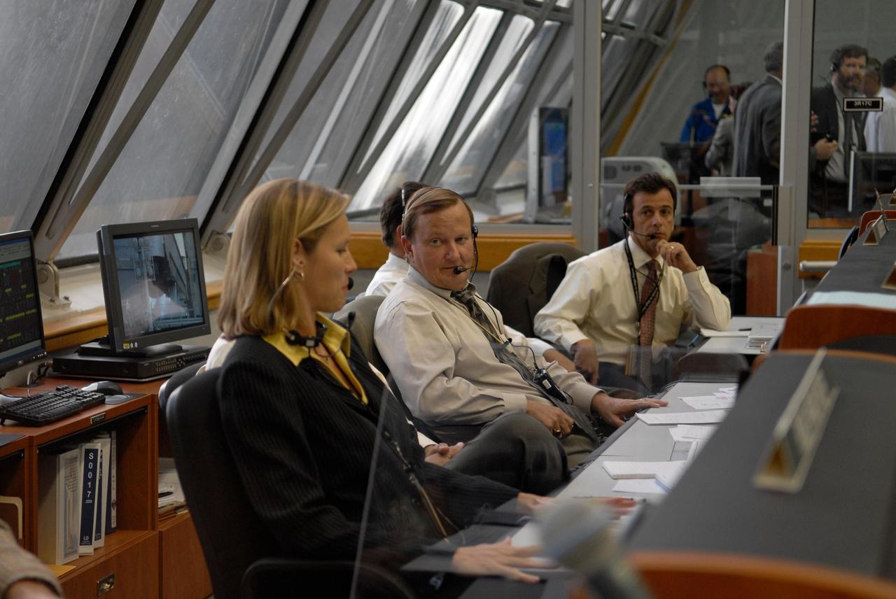 KENNEDY SPACE CENTER, FLA. --  In the firing room of the Launch Control Center at NASA's Kennedy Space Center, NASA Flow Director Stephanie Stilson (left) and Shuttle Launch Director Mike Leinbach (center) talk during the countdown for space shuttle Discovery to launch on mission STS-120.  At right is Assistant Launch Director Doug Lyons. Liftoff was on time at 11:38:19 a.m. EDT.   Discovery carries the Italian-built U.S. Node 2, called Harmony.  During the 14-day STS-120 mission, the crew will install Harmony and move the P6 solar arrays to their permanent position and deploy them. Discovery is expected to complete its mission and return home at 4:47 a.m. EST on Nov. 6. Photo credit: NASA/Kim Shiflett