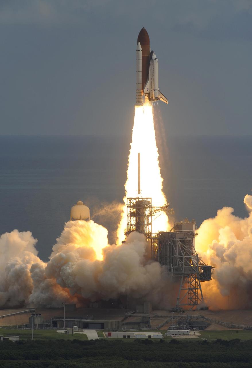 KENNEDY SPACE CENTER, FLA. -- Clouds of smoke and steam reflect the fiery column beneath space shuttle Discovery as it leaps off Launch Pad 39A at NASA's Kennedy Space Center on mission STS-120 to the International Space Station. Liftoff was on time at 11:38:19 a.m. EDT. Discovery carries the Italian-built U.S. Node 2, called Harmony. During the 14-day STS-120 mission, the crew will install Harmony and move the P6 solar arrays to their permanent position and deploy them. Discovery is expected to complete its mission and return home at 4:47 a.m. EST on Nov. 6. Photo courtesy of Nikon/Scott Andrews.