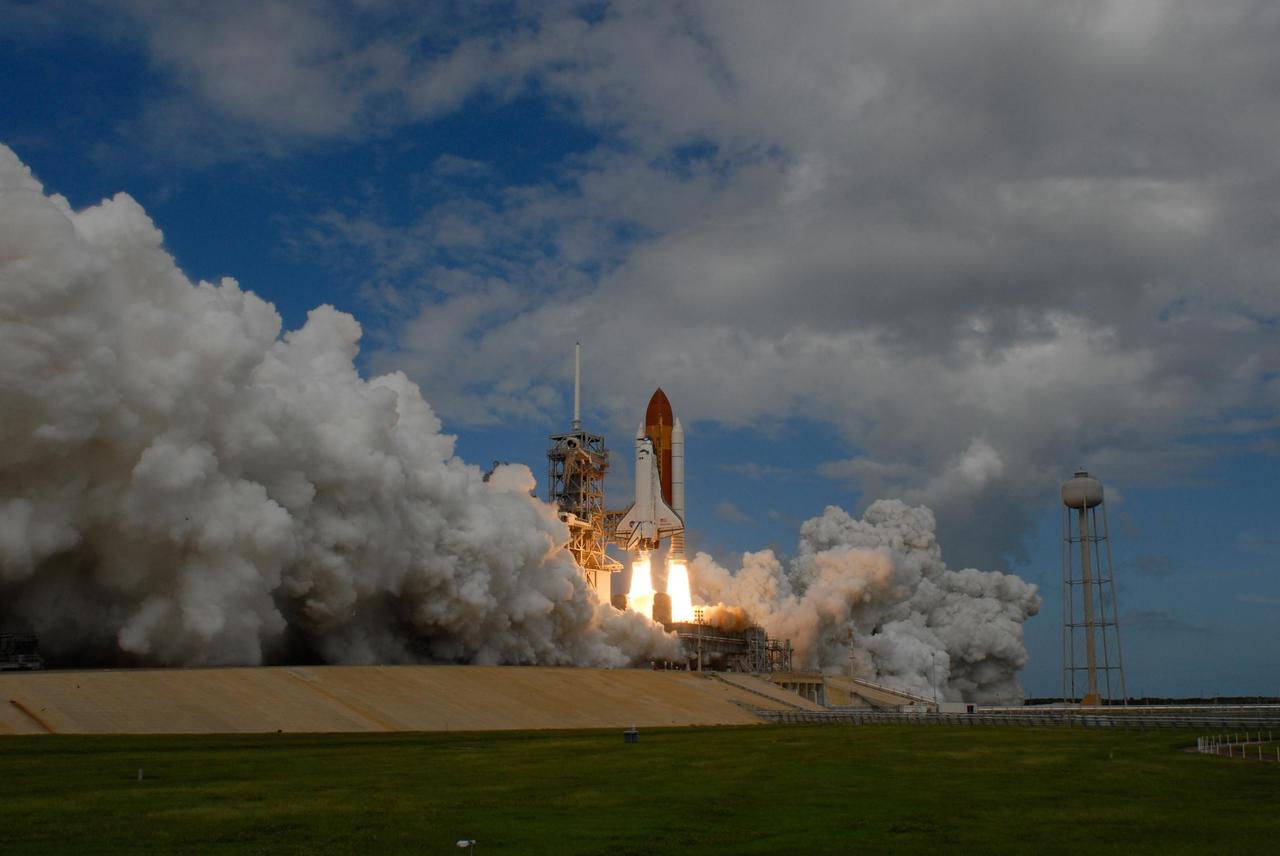 KENNEDY SPACE CENTER, FLA. -- Smoke and steam billow across Launch Pad 39A at NASA's Kennedy Space Center as space shuttle Discovery lifts off on mission STS-120 to the International Space Station. Liftoff was on time at 11:38:19 a.m. EDT. Discovery carries the Italian-built U.S. Node 2, called Harmony. During the 14-day STS-120 mission, the crew will install Harmony and move the P6 solar arrays to their permanent position and deploy them. Discovery is expected to complete its mission and return home at 4:47 a.m. EST on Nov. 6. Photo credit: NASA/Sandra Joseph, Tony Gray & Robert Murray