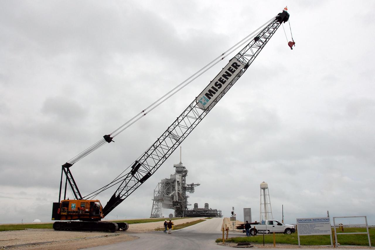 KENNEDY SPACE CENTER, FLA. -- A large crawler crane stops on the ramp to Launch Pad 39B. At the top of the pad can be seen a mobile launcher platform with the rotating and fixed service structures at left. The current 80-foot lightning mast can be seen atop the fixed structure. The crane with its 70-foot boom will be used to construct a new lightning protection system for the Constellation Program and Ares/Orion launches. Pad B will be the site of the first Ares vehicle launch, including Ares I-X which is scheduled for April 2009. Photo credit: NASA/Kim Shiflett